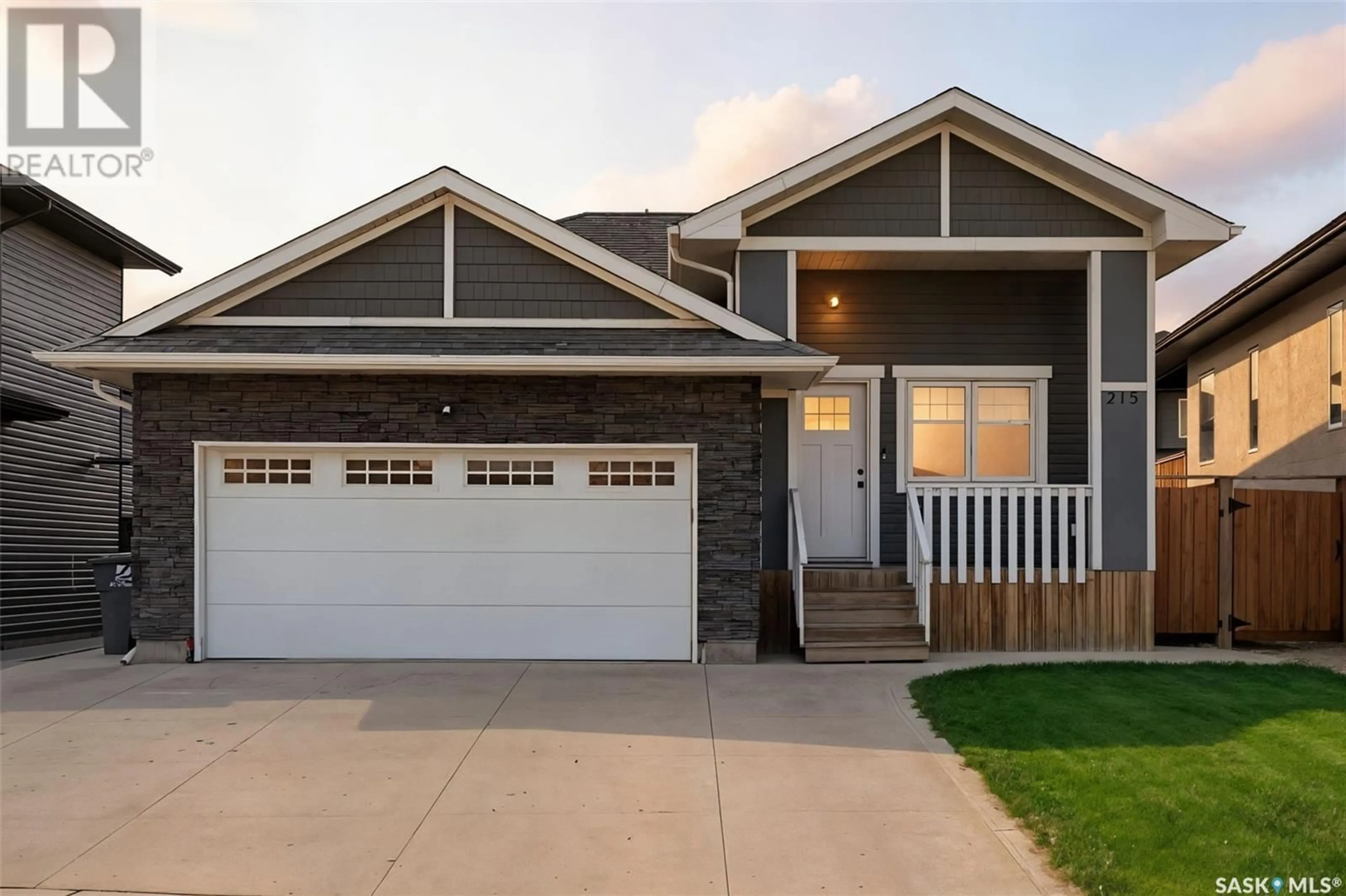 Home with vinyl exterior material, street for 215 BOLSTAD MANOR, Saskatoon Saskatchewan S7W0Y1