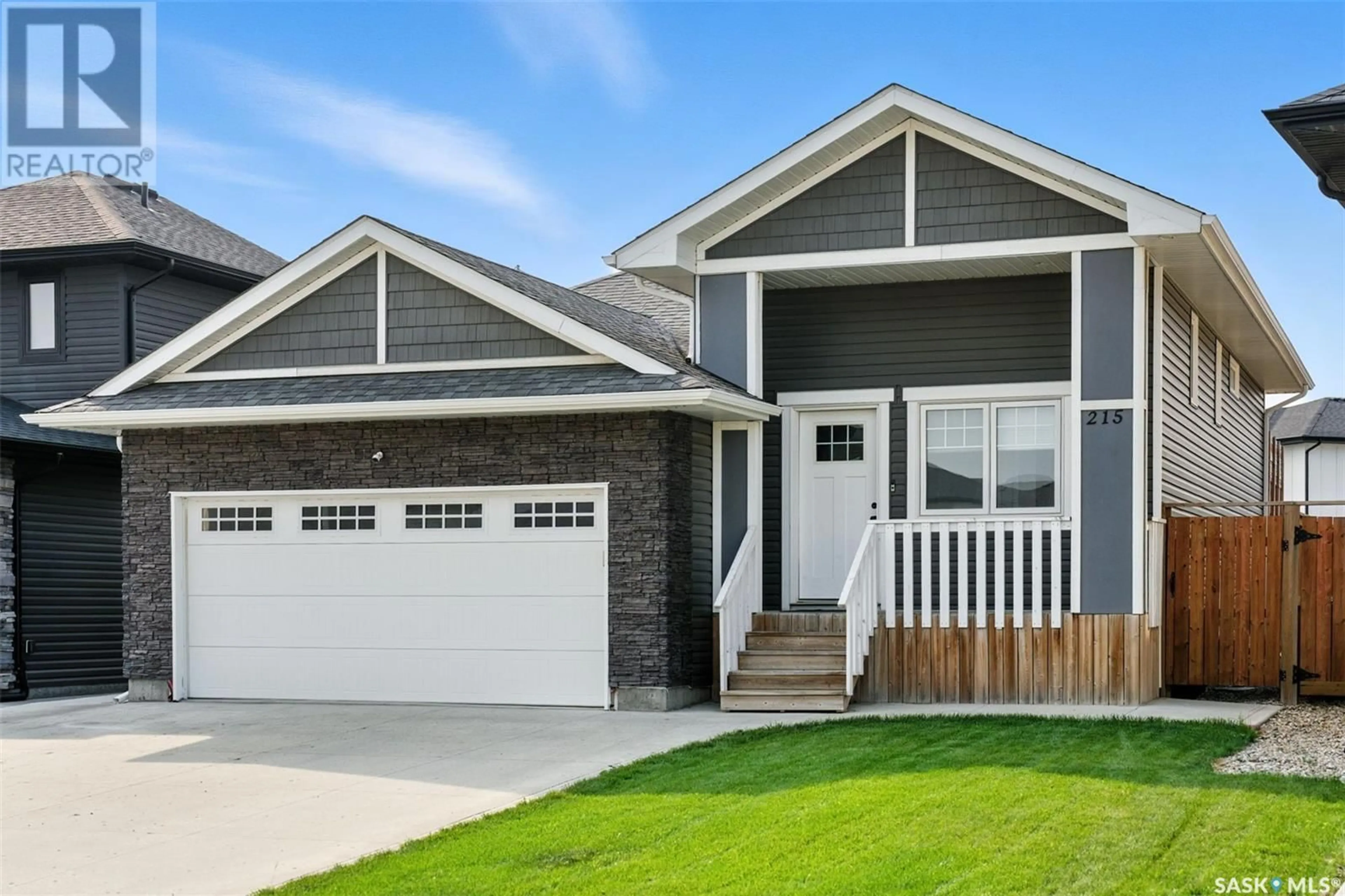 Home with vinyl exterior material, street for 215 BOLSTAD MANOR, Saskatoon Saskatchewan S7W0Y1