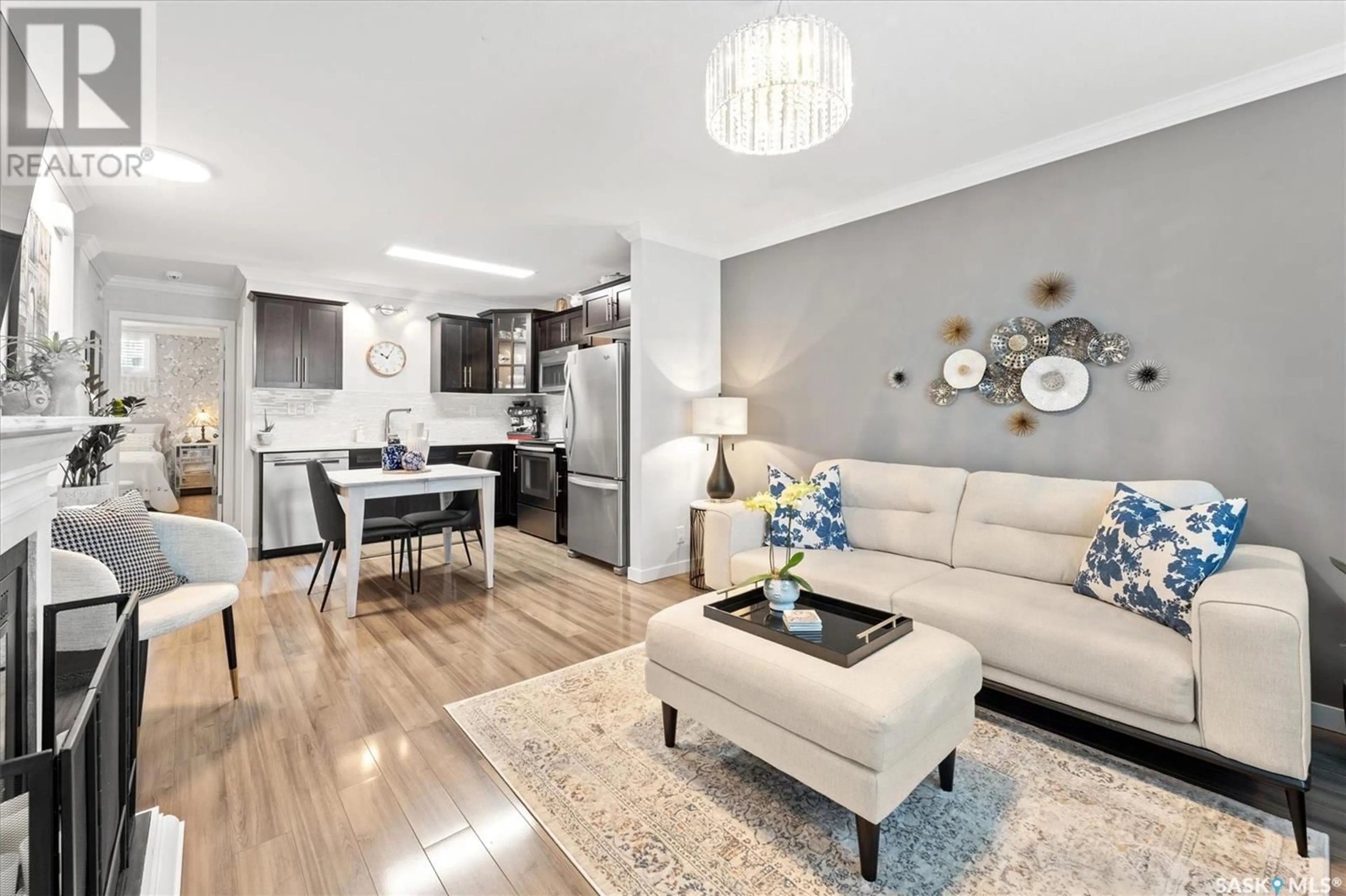Living room with furniture, wood/laminate floor for 620 - 355 CORNISH ROAD, Saskatoon Saskatchewan S7T0Y3