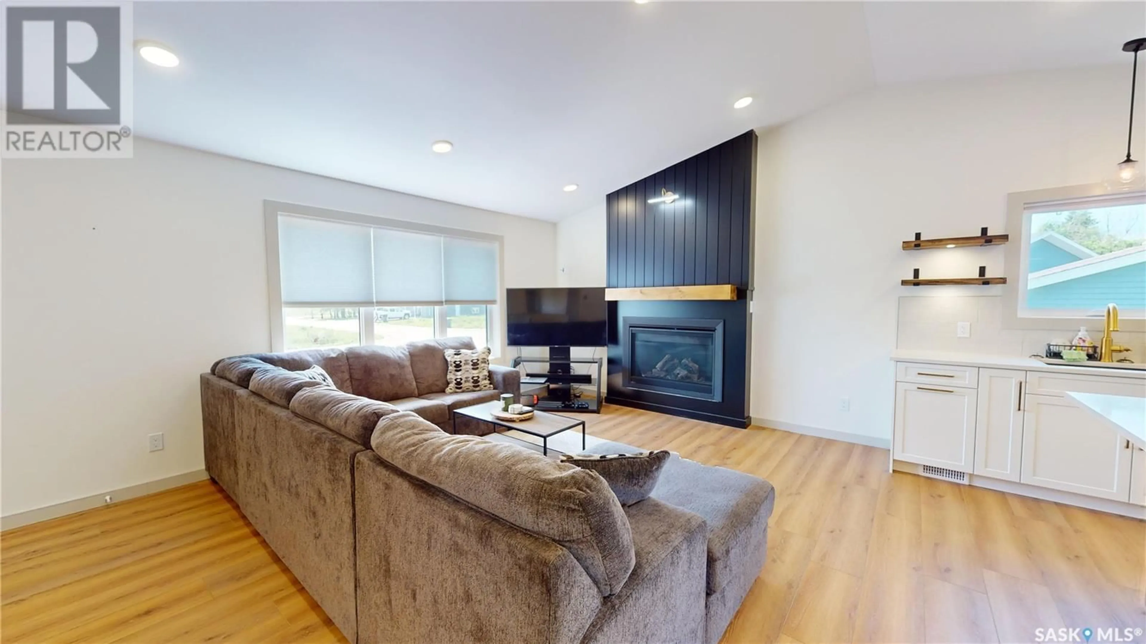 Living room with furniture, wood/laminate floor for 209 WILLOW CRESCENT, Waldheim Saskatchewan S0K4R0
