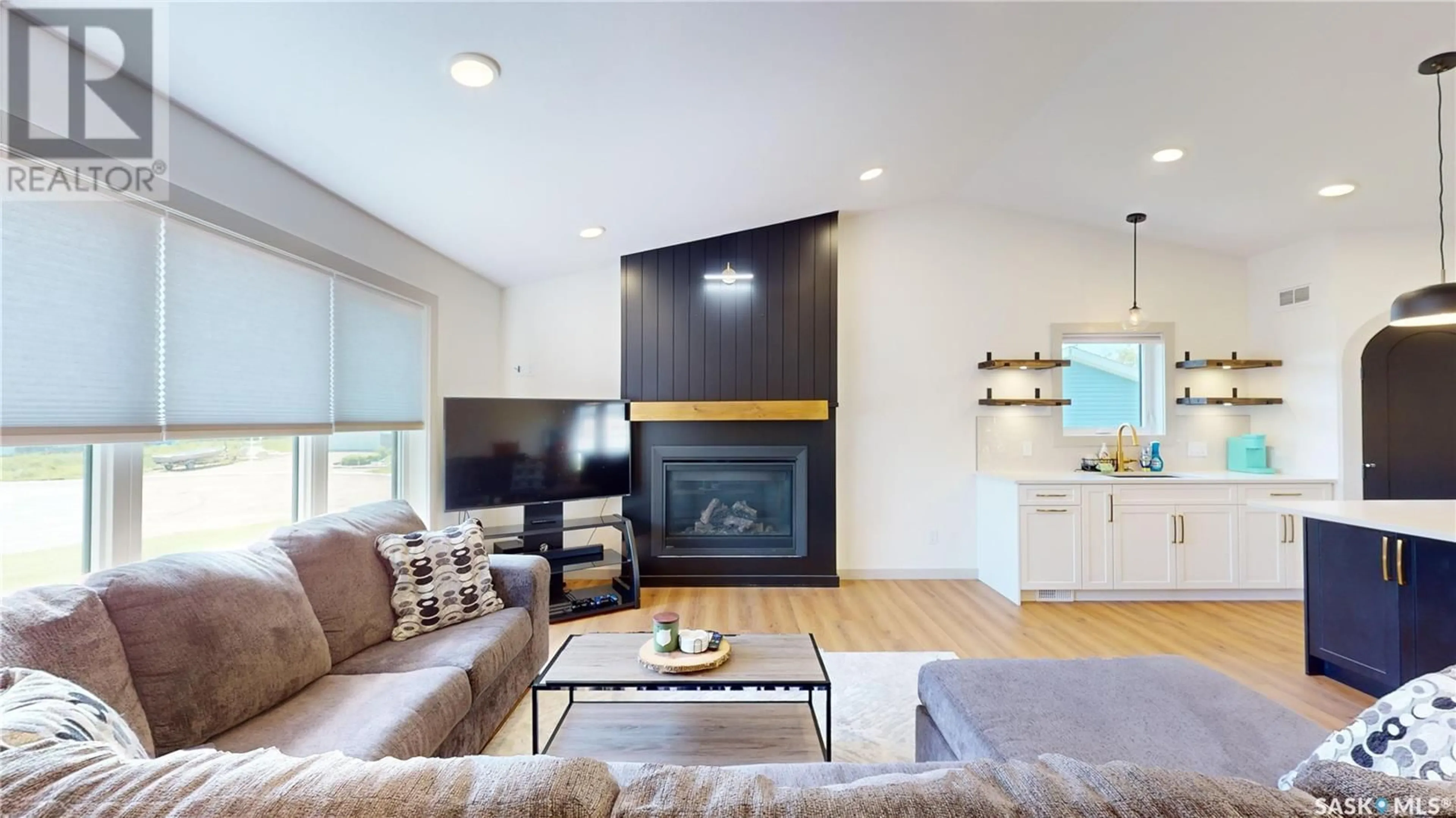 Living room with furniture, wood/laminate floor for 209 WILLOW CRESCENT, Waldheim Saskatchewan S0K4R0