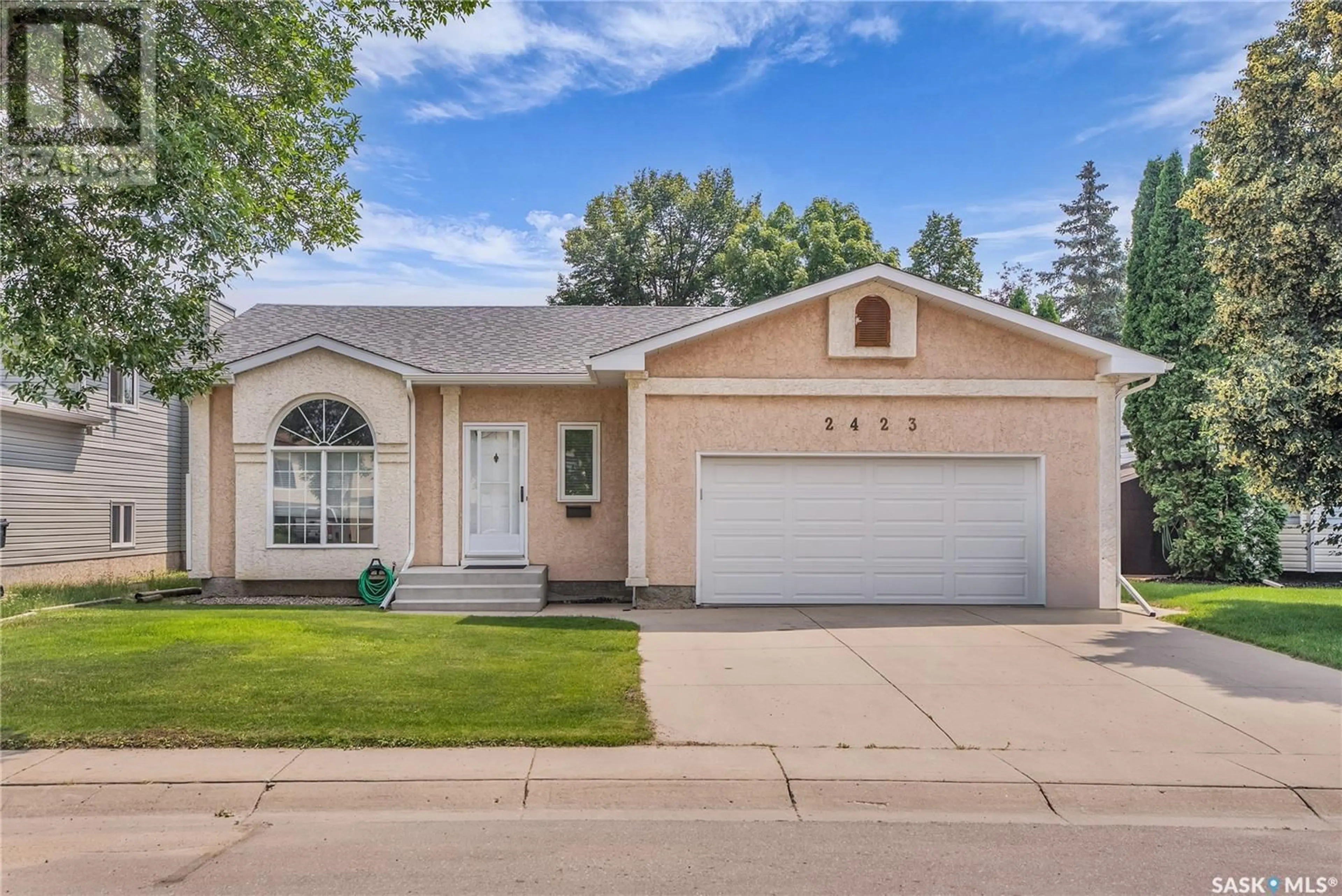Home with vinyl exterior material, street for 2423 KENDERDINE ROAD, Saskatoon Saskatchewan S7N4A4