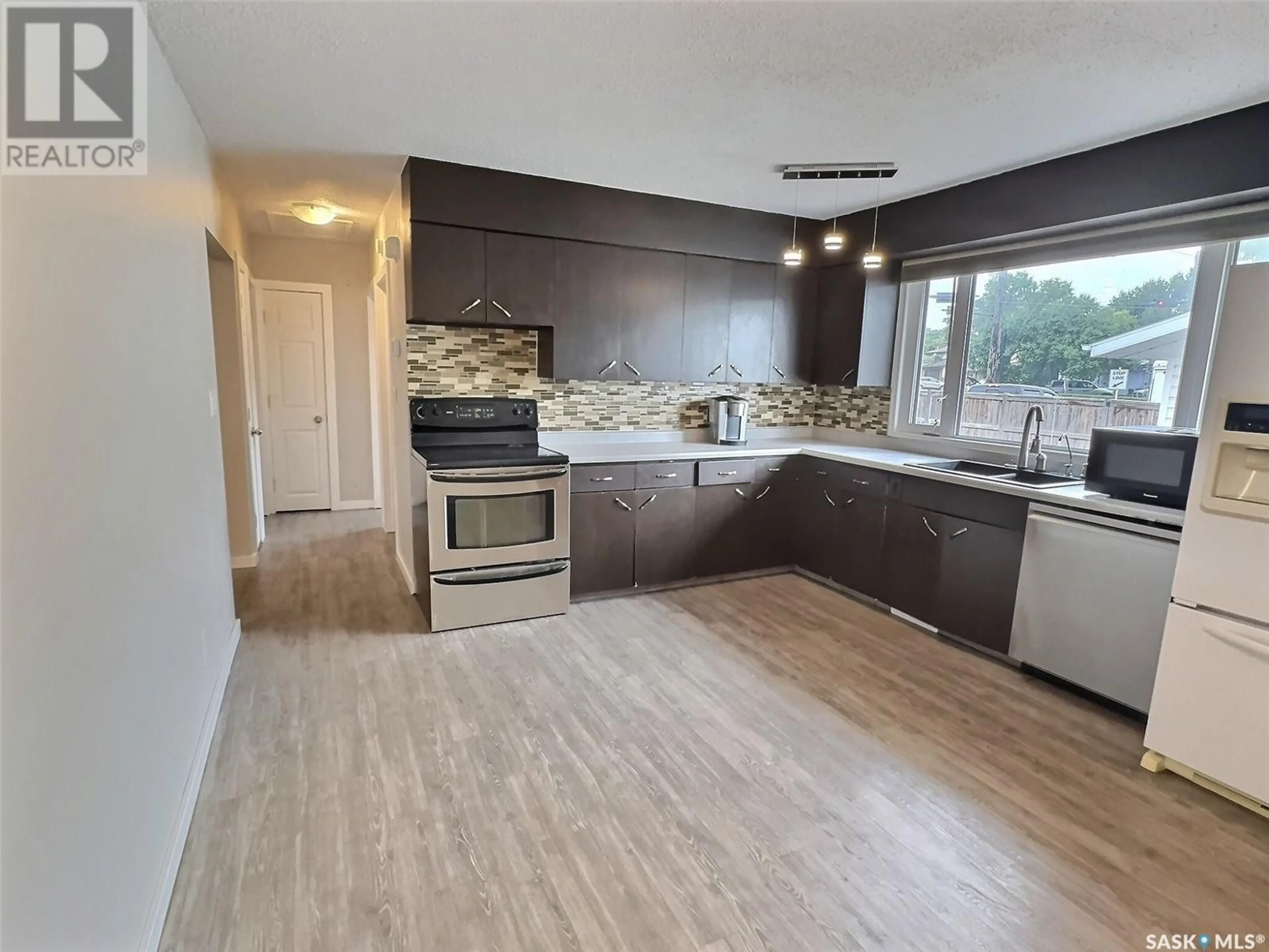 Open concept kitchen, wood/laminate floor for 264 DUNCAN ROAD, Estevan Saskatchewan S4A0A4
