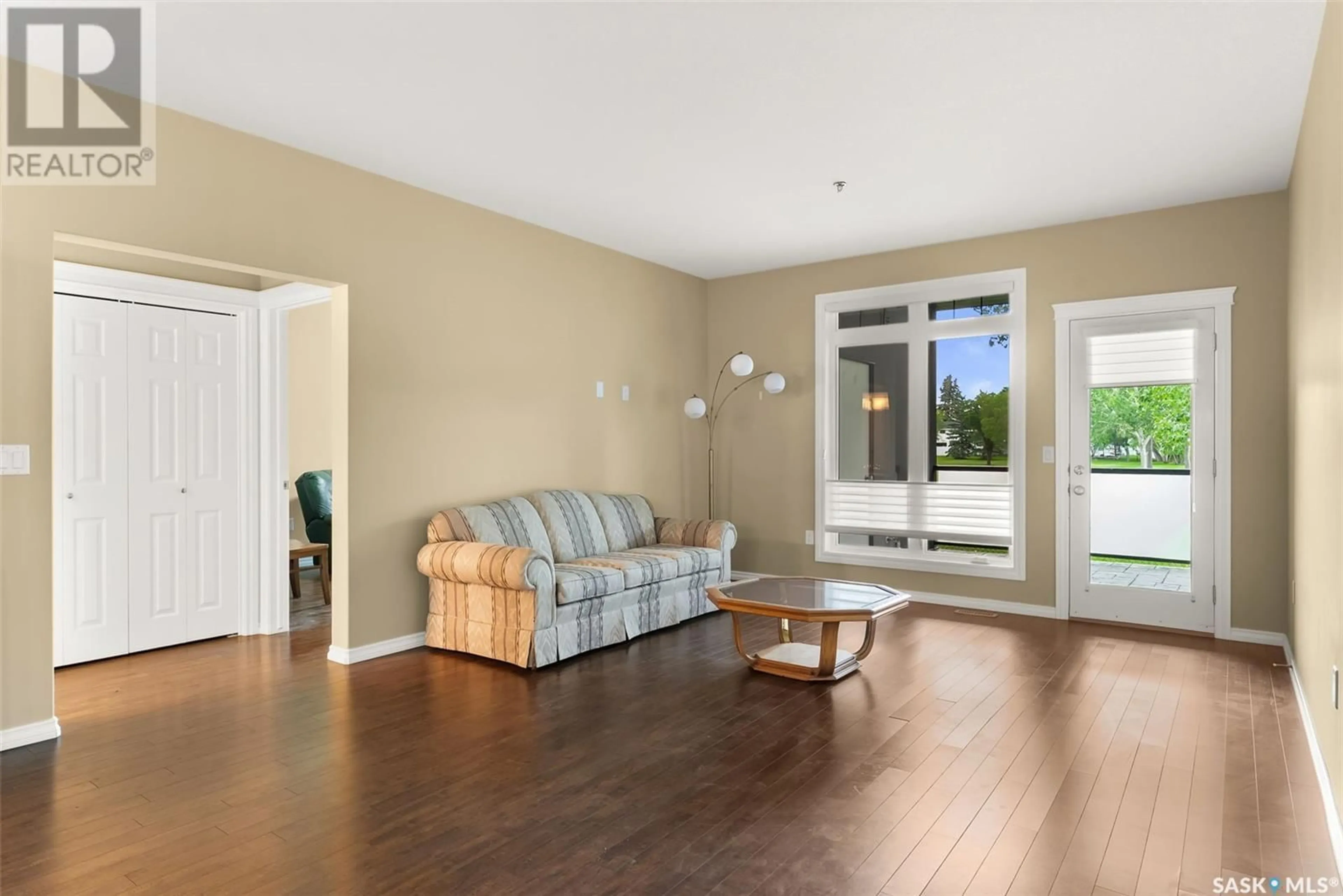 Living room with furniture, wood/laminate floor for 4721 - 115 MCTAVISH STREET, Regina Saskatchewan S4S6H2