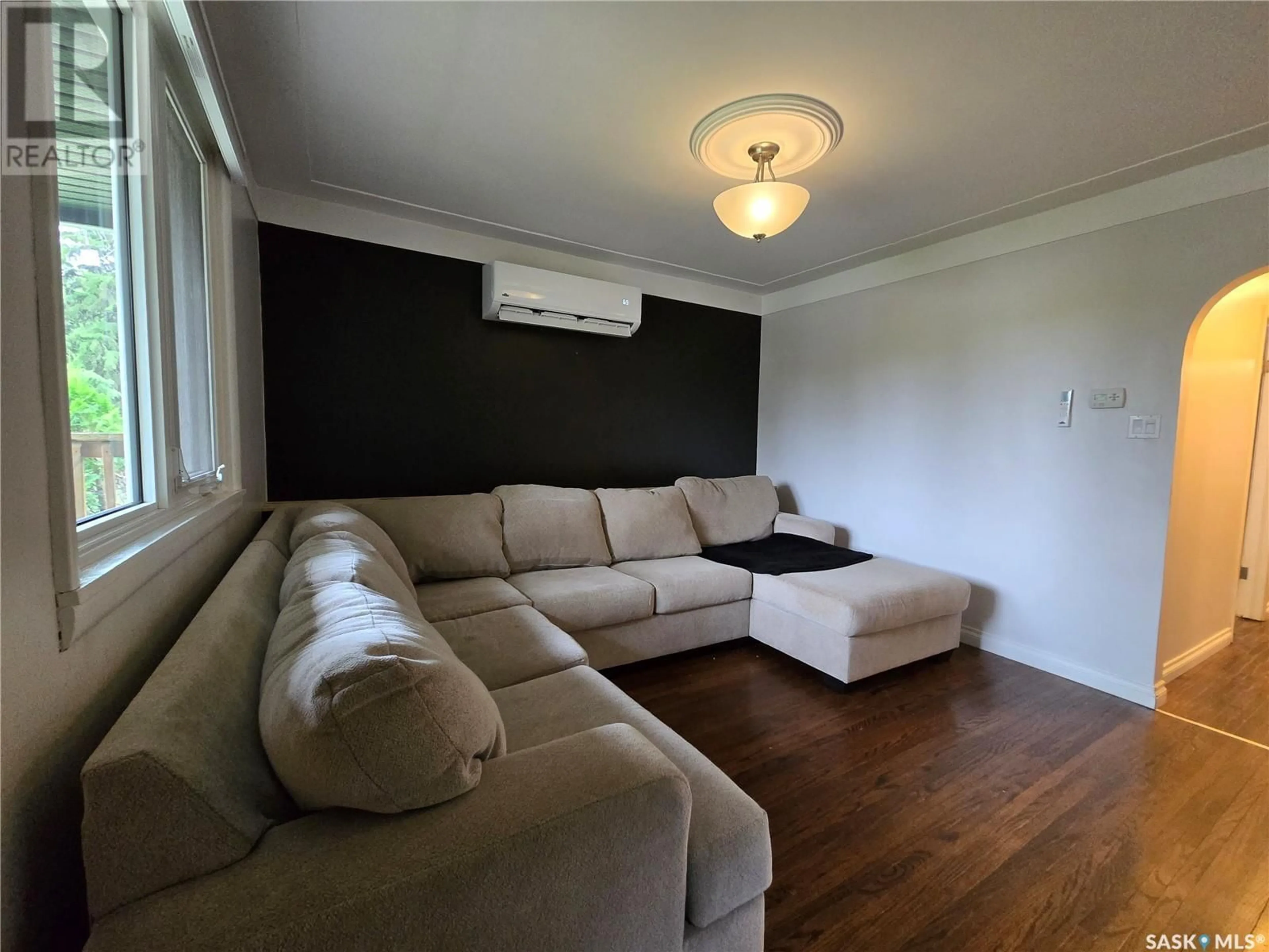 Living room with furniture, wood/laminate floor for E - 300 MAPLE STREET, Saskatoon Saskatchewan S7J0A5