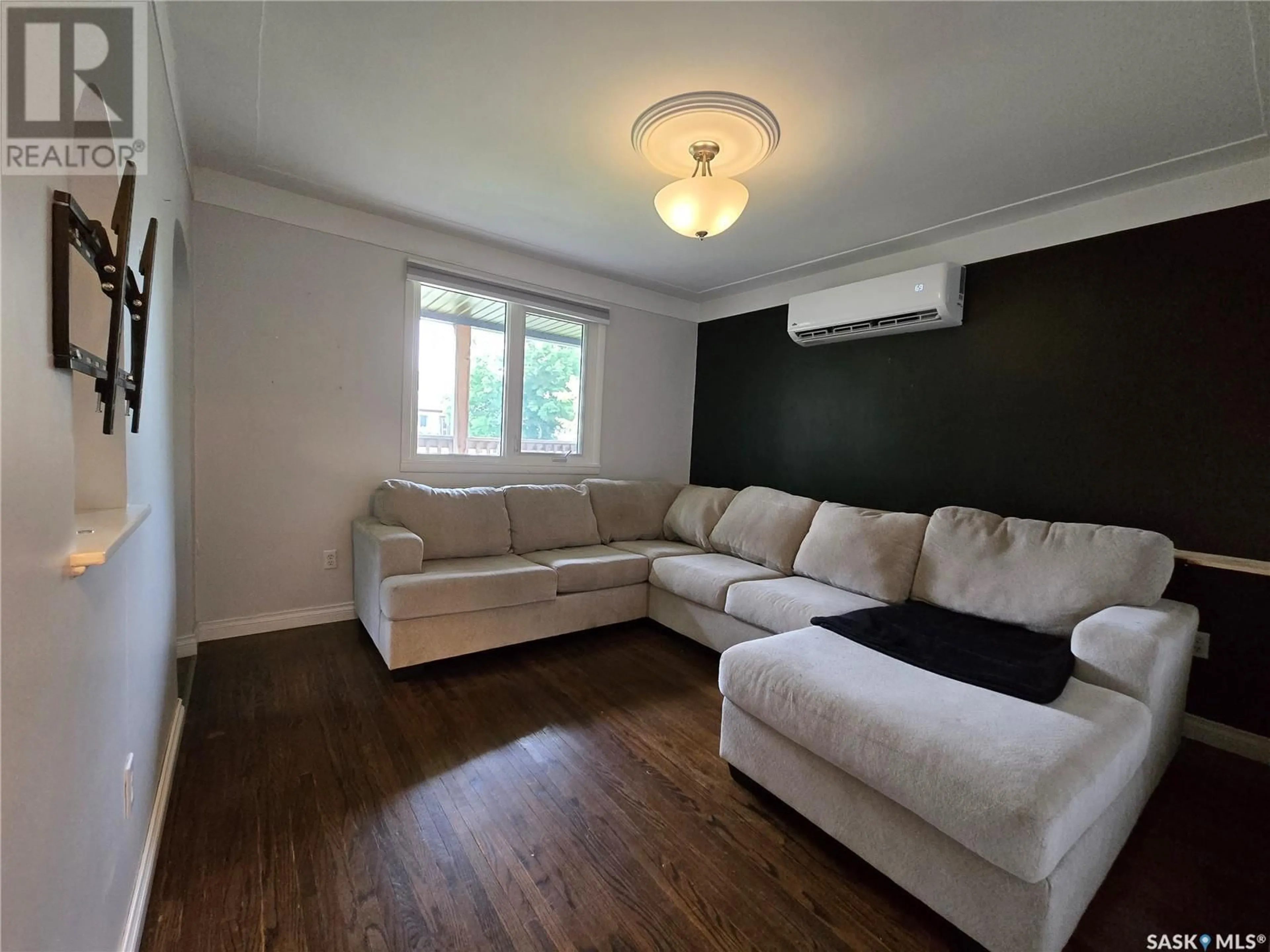 Living room with furniture, wood/laminate floor for E - 300 MAPLE STREET, Saskatoon Saskatchewan S7J0A5