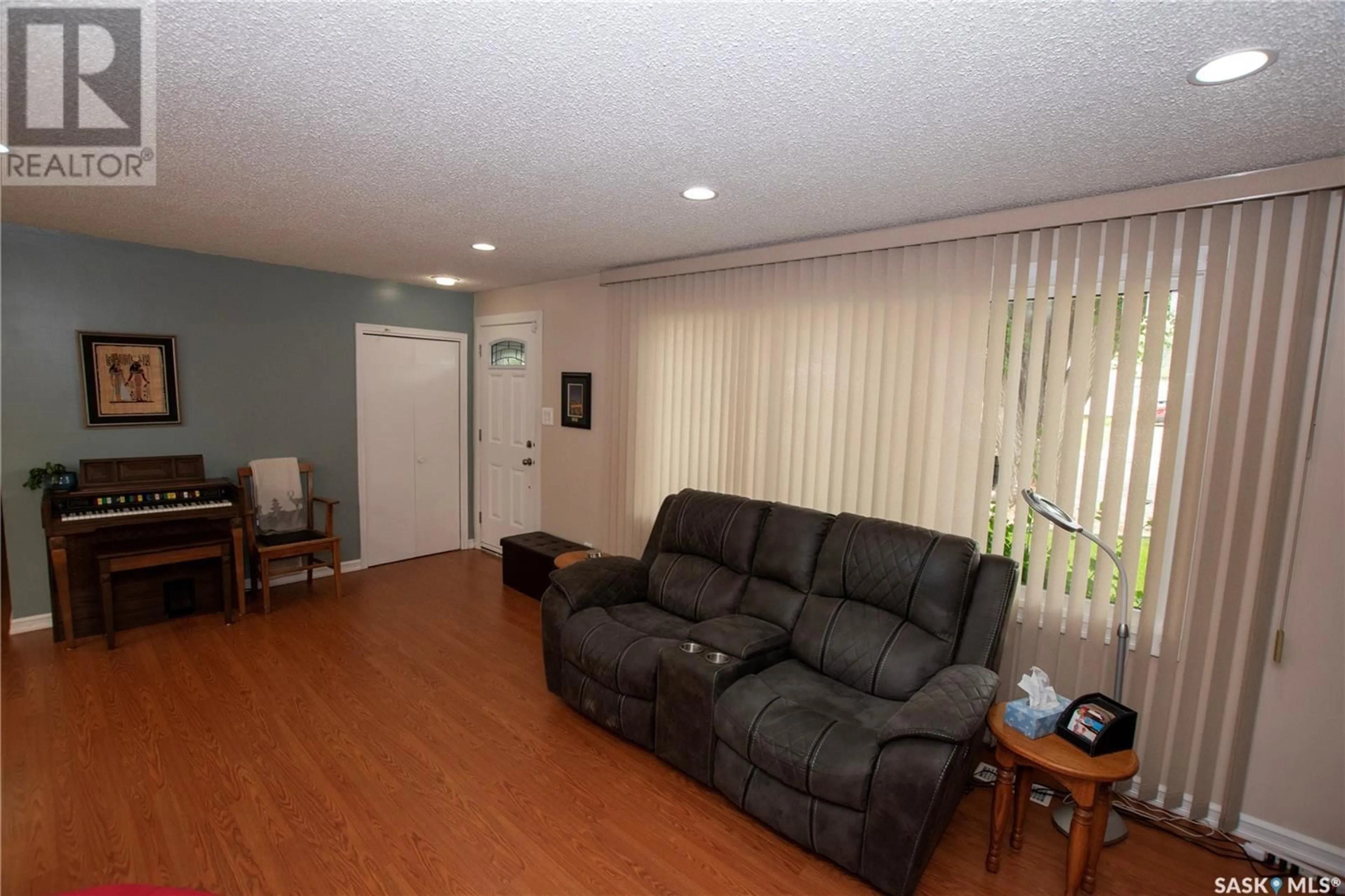 Living room with furniture, wood/laminate floor for 1614 8TH AVENUE, Saskatoon Saskatchewan S7K2X9