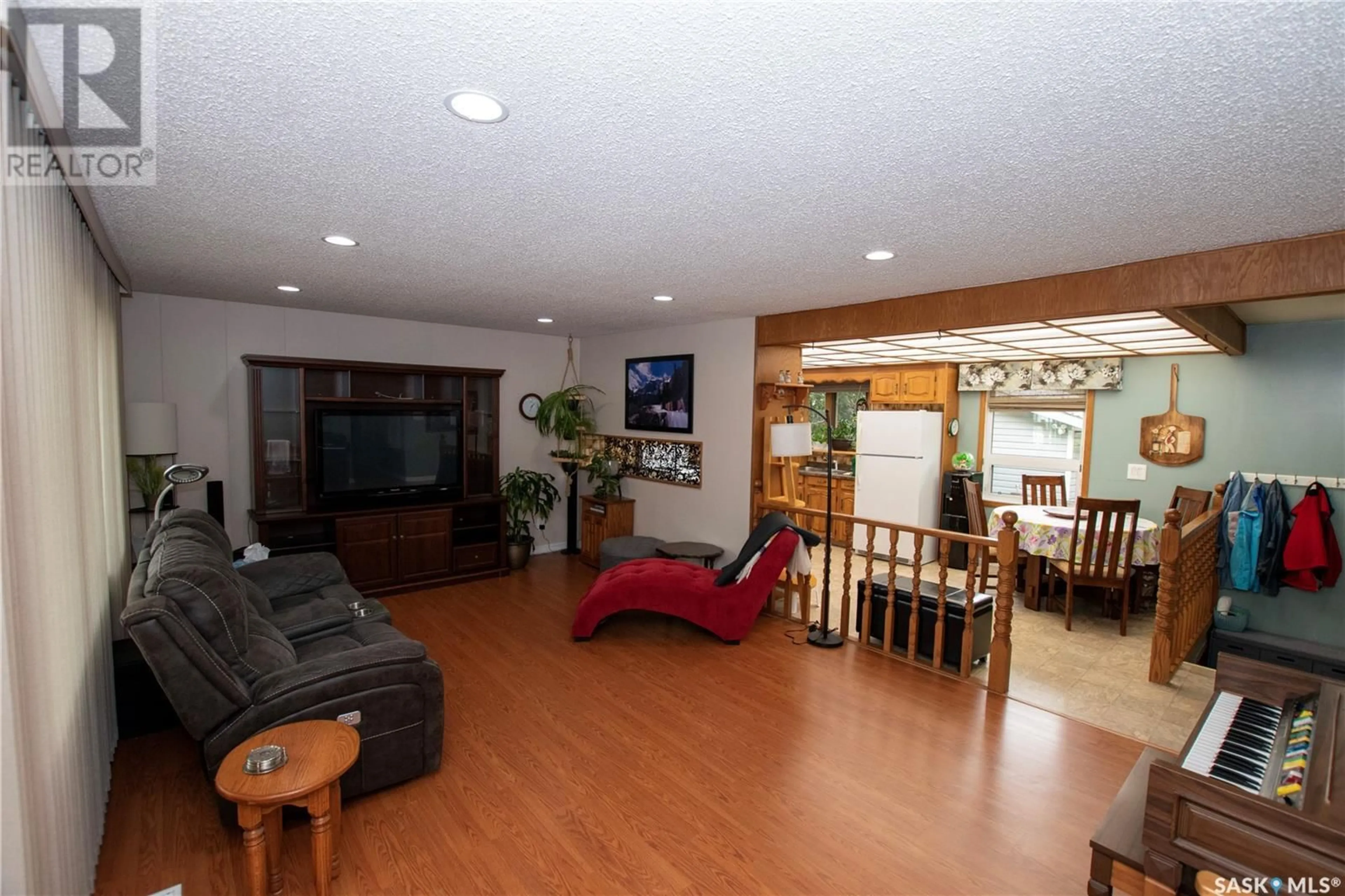 Living room with furniture, wood/laminate floor for 1614 8TH AVENUE, Saskatoon Saskatchewan S7K2X9