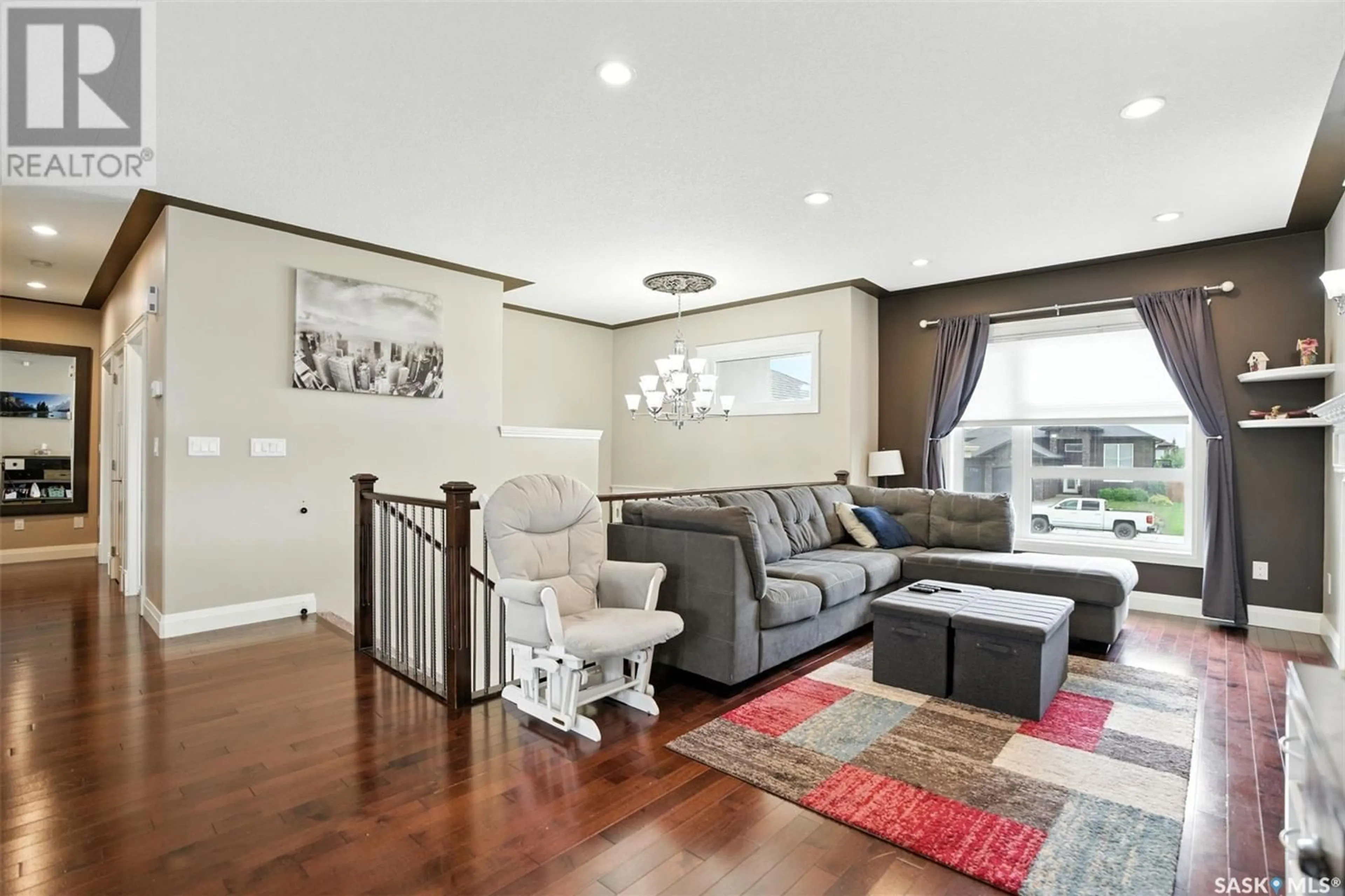 Living room with furniture, wood/laminate floor for 310 AUGUSTA BOULEVARD, Warman Saskatchewan S0K4S1