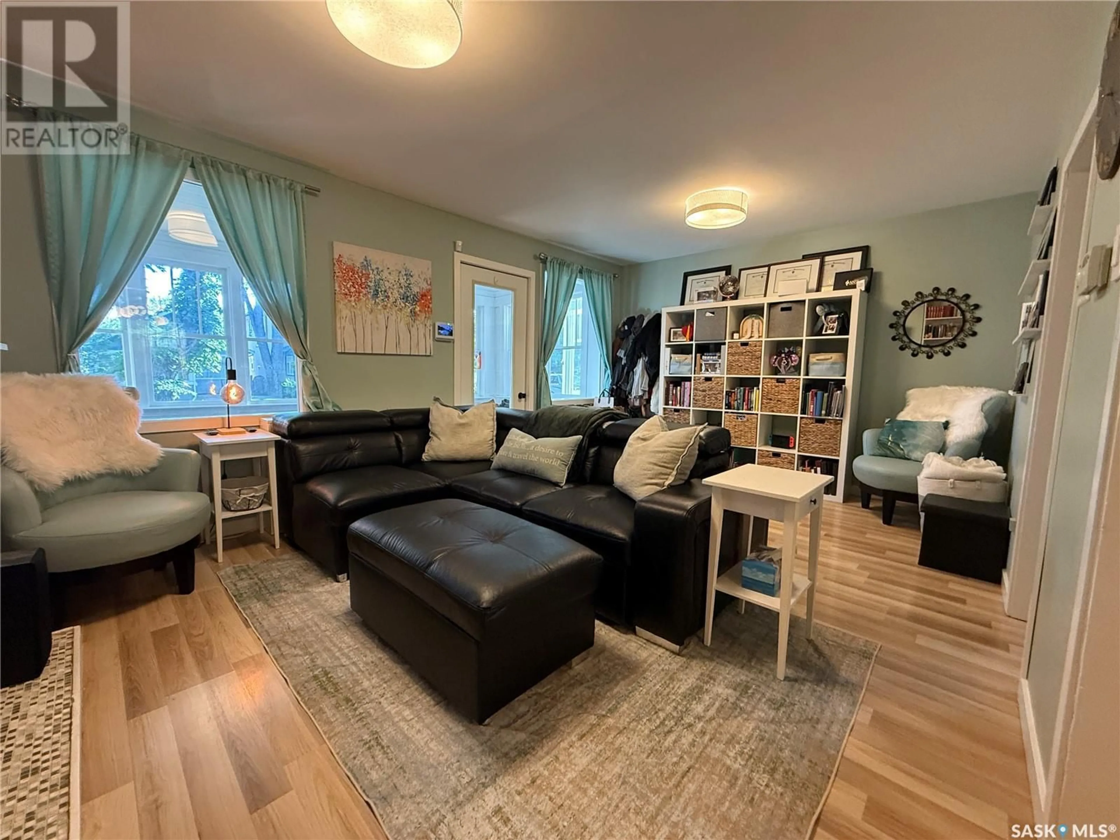 Living room with furniture, wood/laminate floor for 202 28TH STREET, Saskatoon Saskatchewan S7L0K3