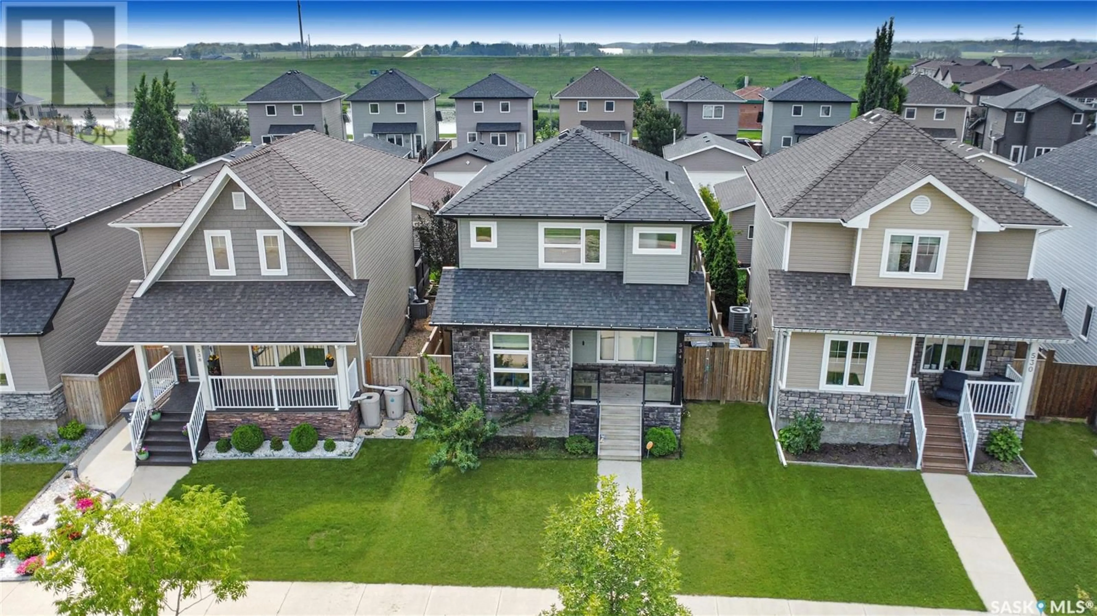 A pic from outside/outdoor area/front of a property/back of a property/a pic from drone, street for 534 STONEBRIDGE COMMON, Saskatoon Saskatchewan S7T0N8