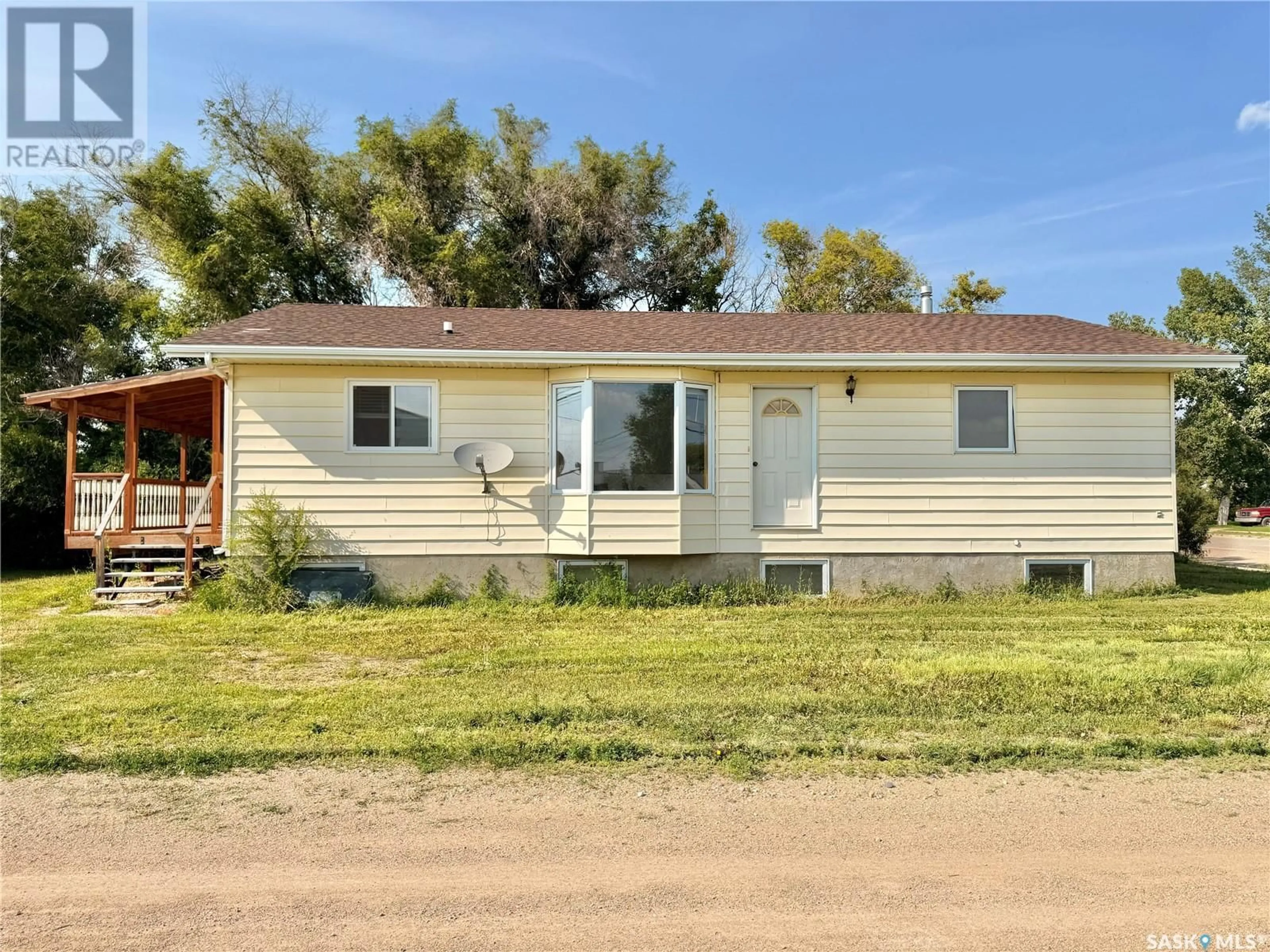 Home with vinyl exterior material, street for 100 1ST AVENUE, Lucky Lake Saskatchewan S0L1Z0
