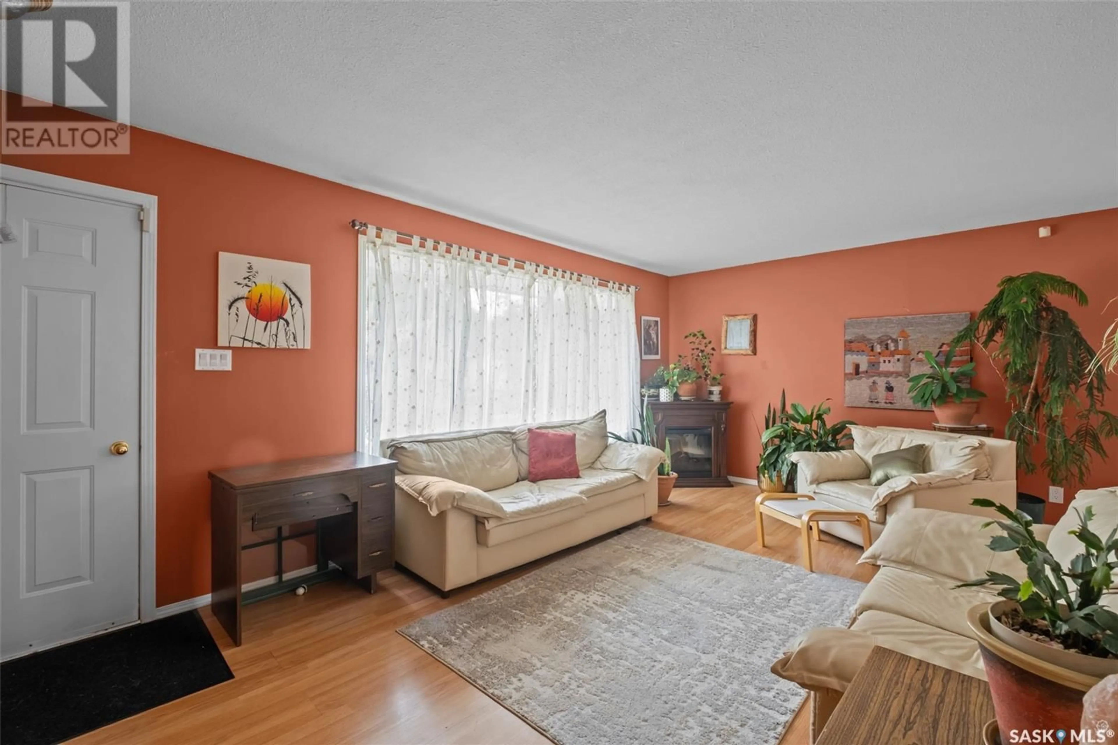 Living room with furniture, wood/laminate floor for 488 BENNETT DRIVE, Prince Albert Saskatchewan S6V6H6