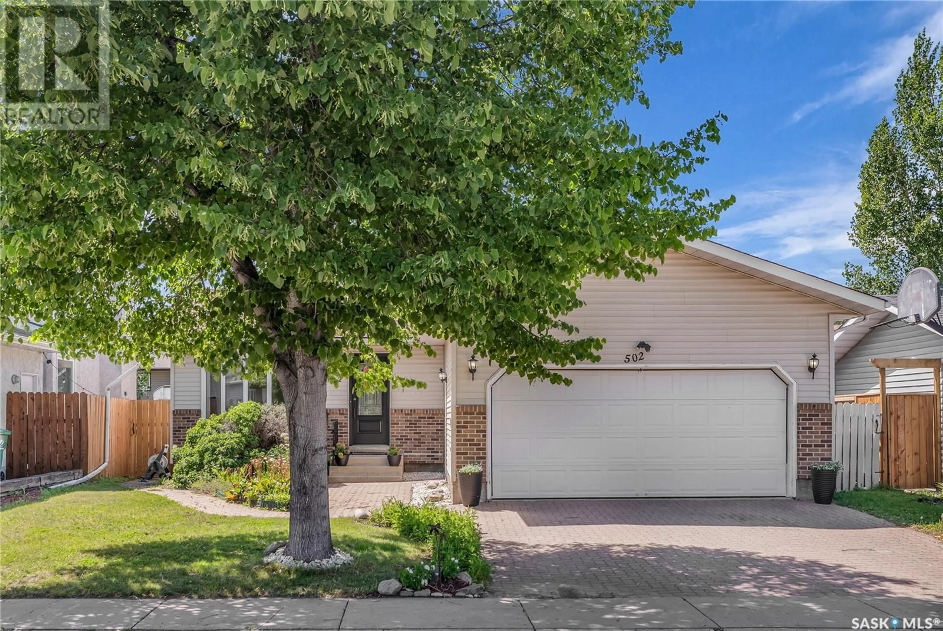 Home with vinyl exterior material, street for 502 BRIGHTSAND CRESCENT, Saskatoon Saskatchewan S7J4Y3