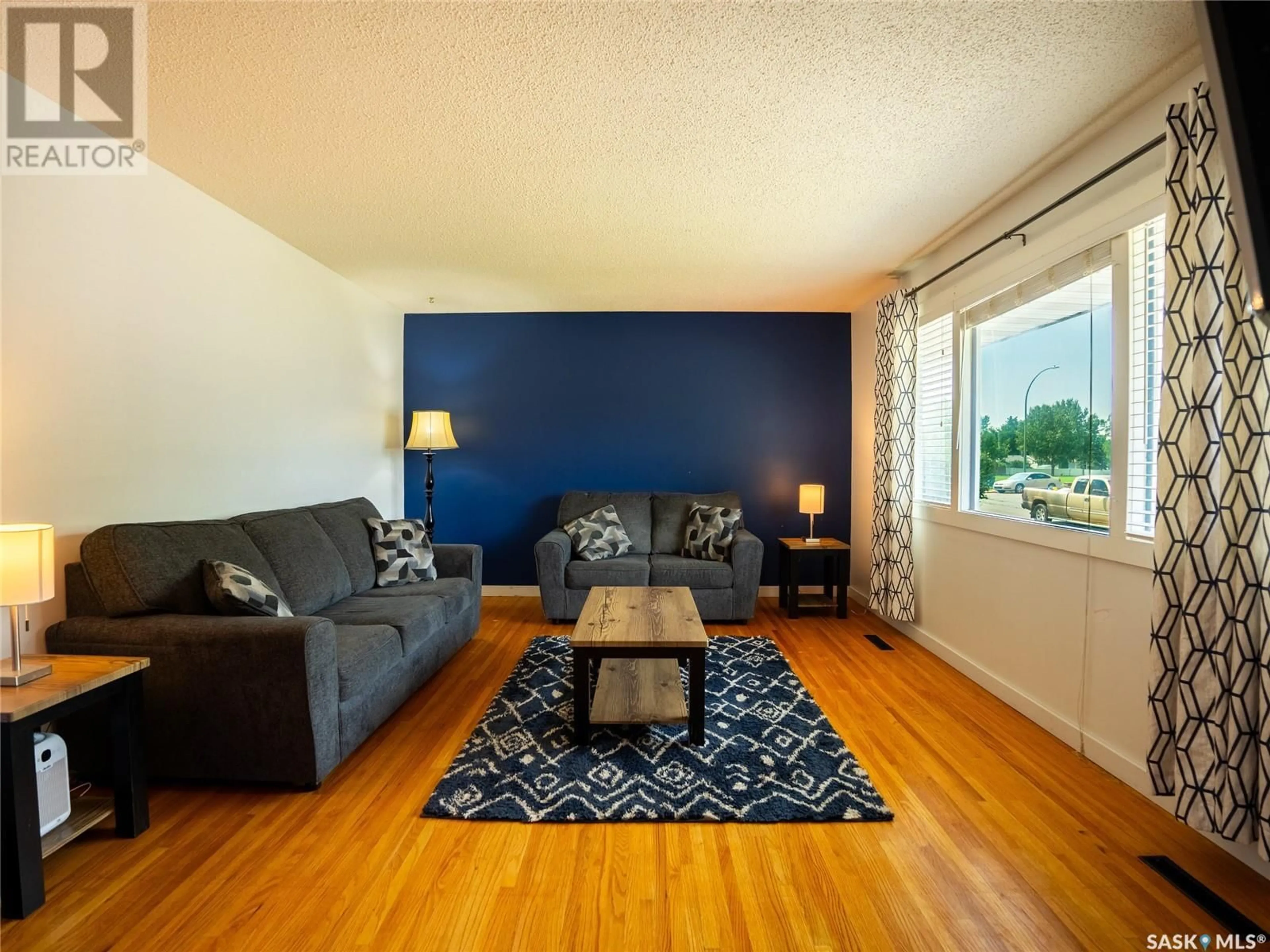 Living room with furniture, wood/laminate floor for 37 LORIMER CRESCENT, Regina Saskatchewan S4R3X9