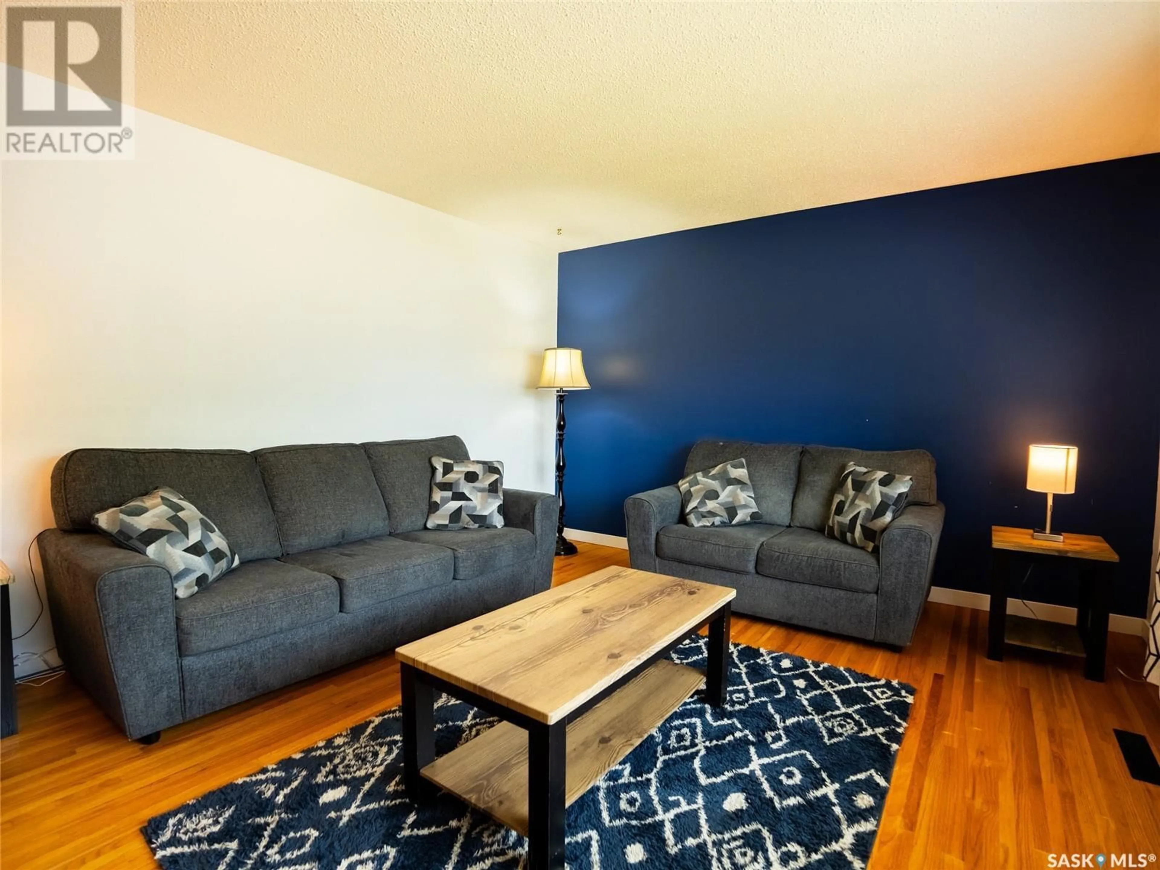 Living room with furniture, wood/laminate floor for 37 LORIMER CRESCENT, Regina Saskatchewan S4R3X9