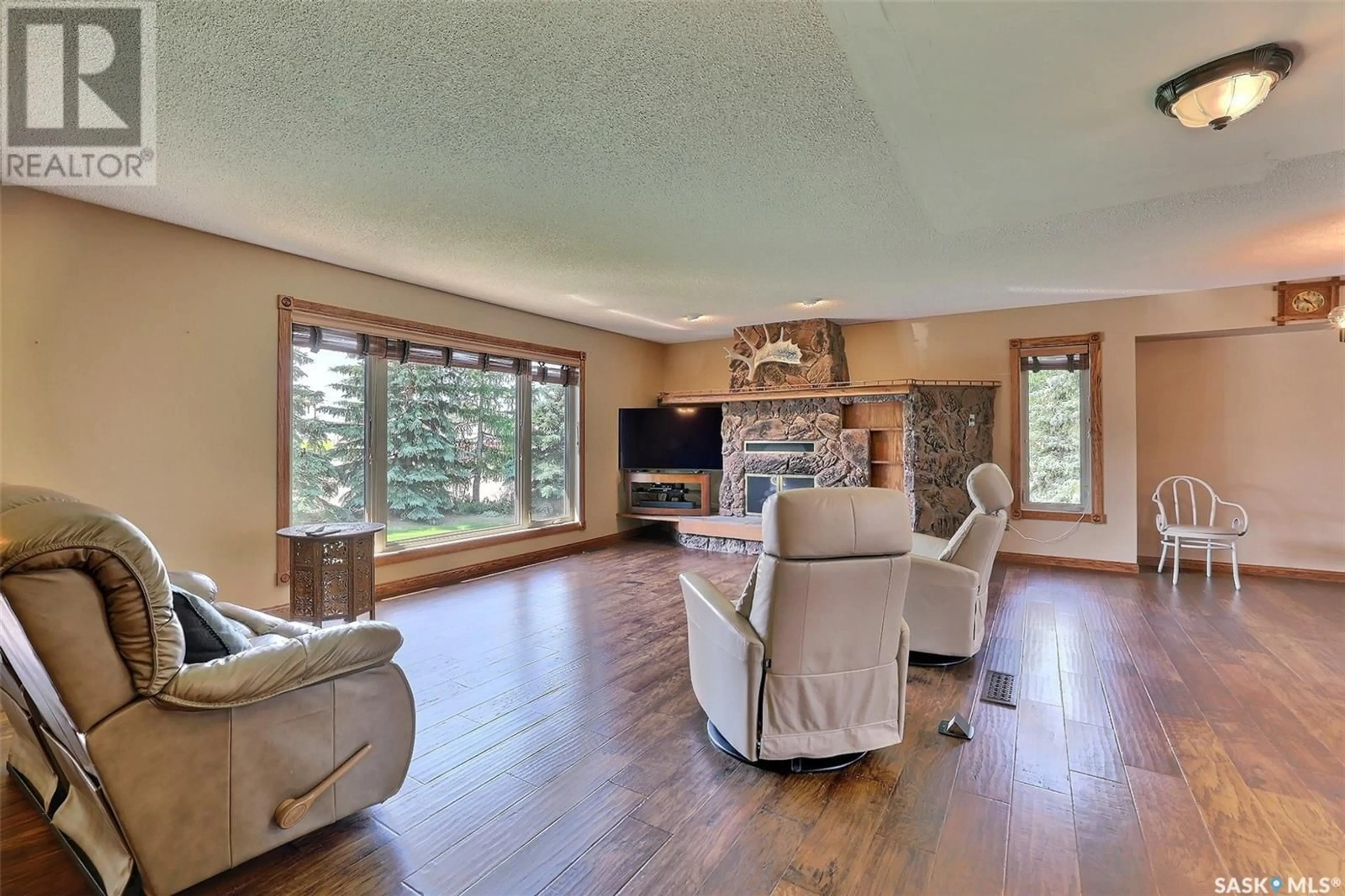 Living room with furniture, wood/laminate floor for MORLEY ACREAGE, Francis Rm No. 127 Saskatchewan S0G1V0