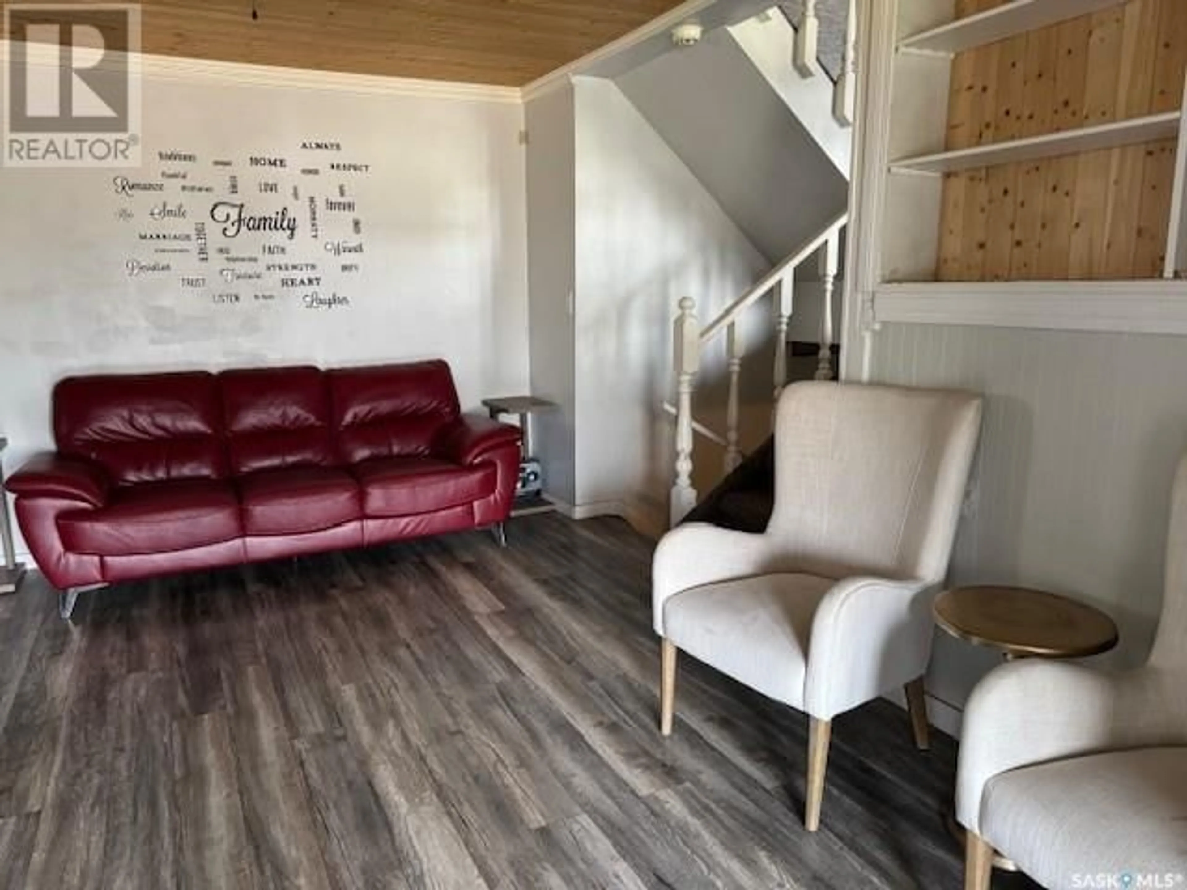 Living room with furniture, wood/laminate floor for 1482 110TH STREET, North Battleford Saskatchewan S9A2J2