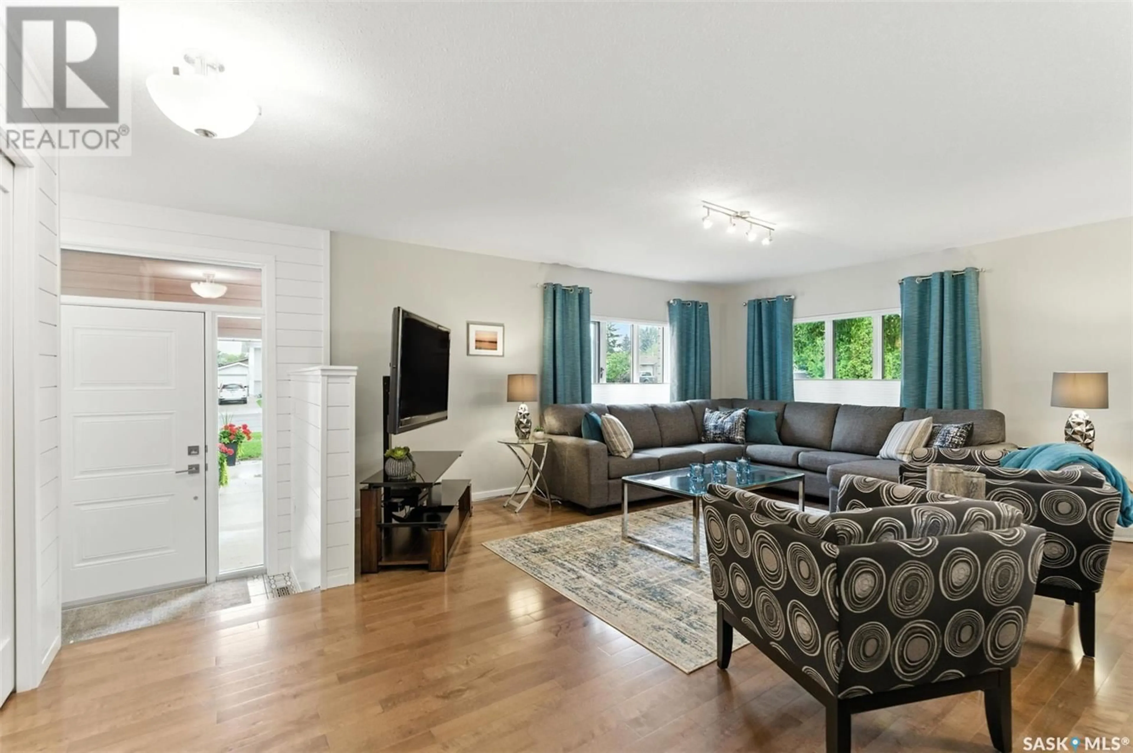 Living room with furniture, wood/laminate floor for 519 SILVERWOOD ROAD, Saskatoon Saskatchewan S7K6X3