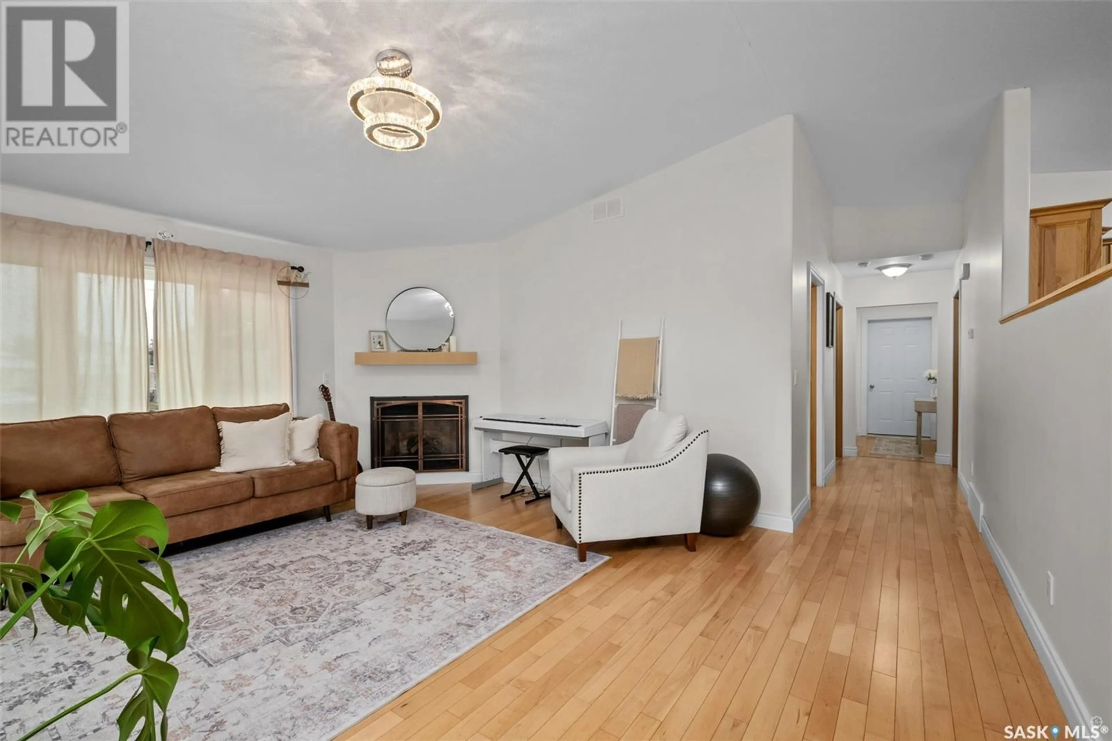 Living room with furniture, wood/laminate floor for 1255 18TH STREET, Prince Albert Saskatchewan S6V4B6