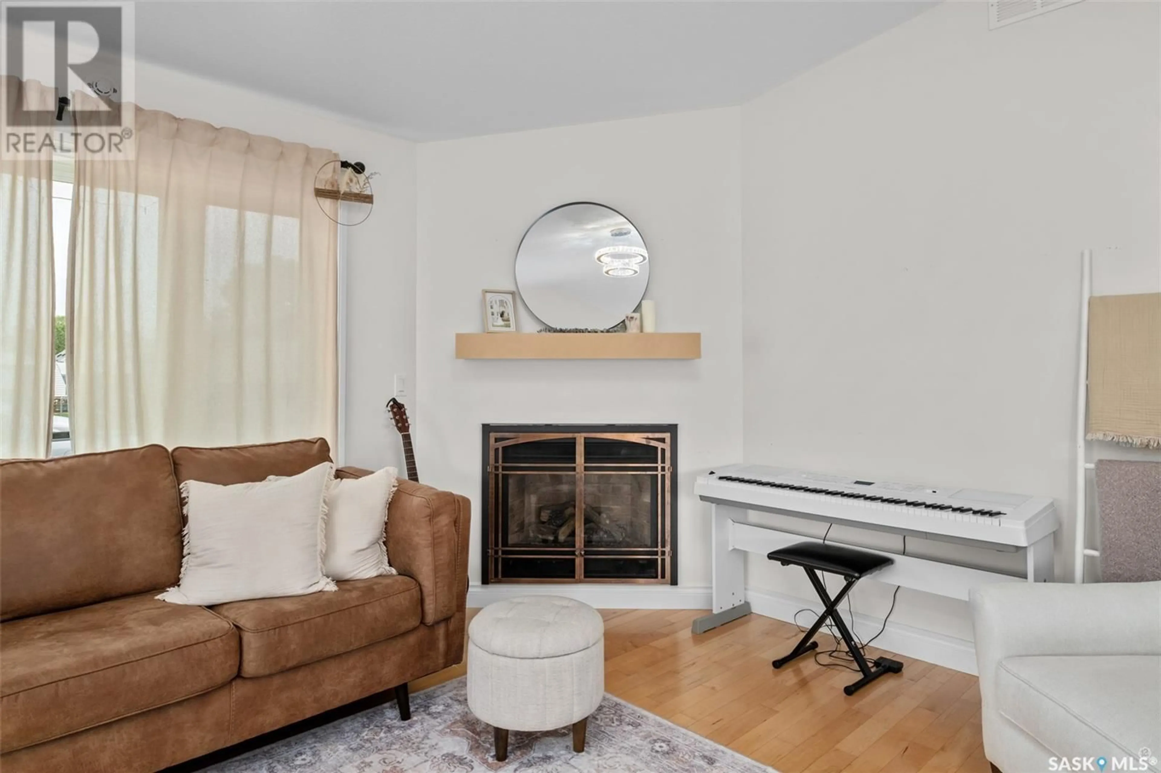 Living room with furniture, wood/laminate floor for 1255 18TH STREET, Prince Albert Saskatchewan S6V4B6