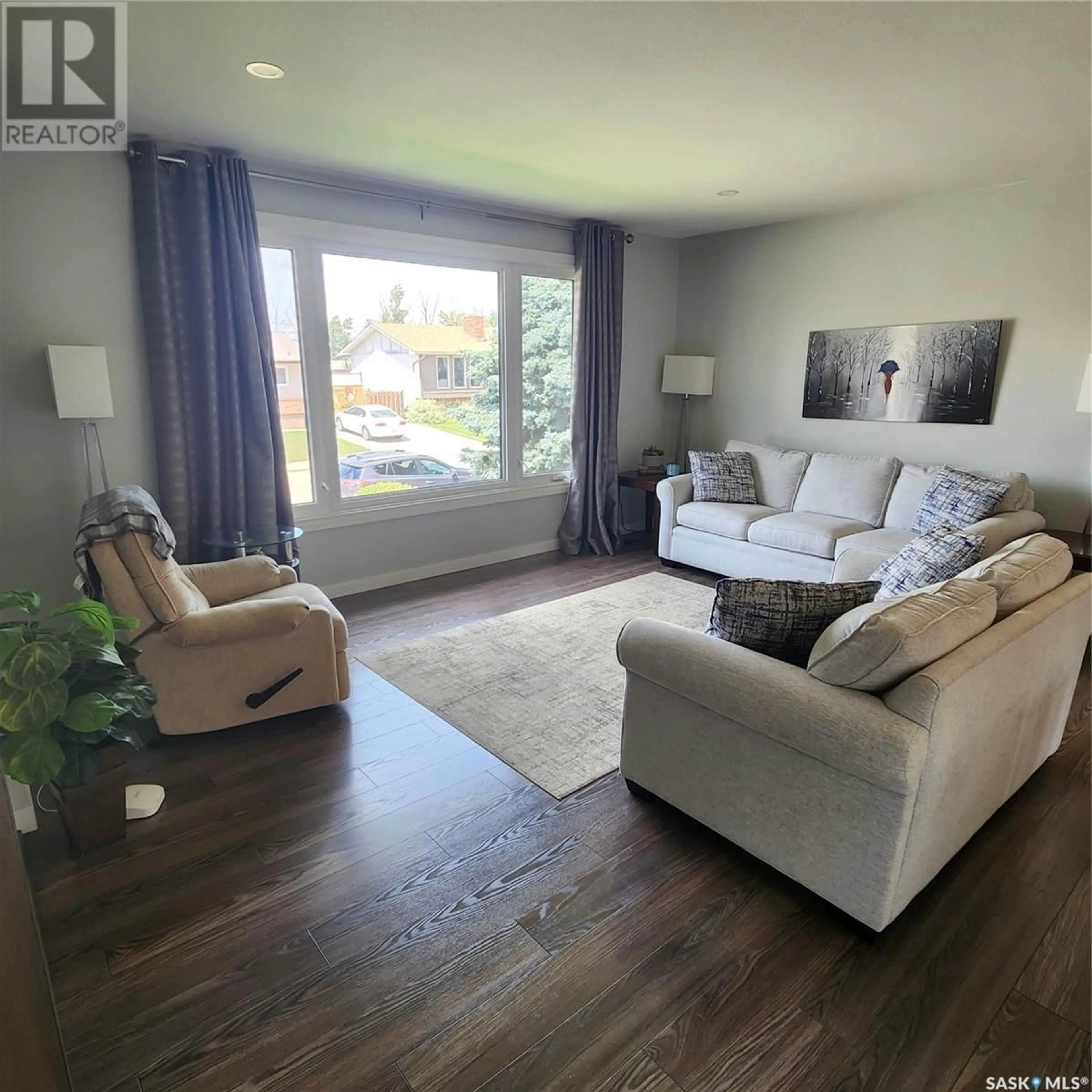 Living room with furniture, wood/laminate floor for 1346 PRINCESS CRESCENT, Moose Jaw Saskatchewan S6H6S9