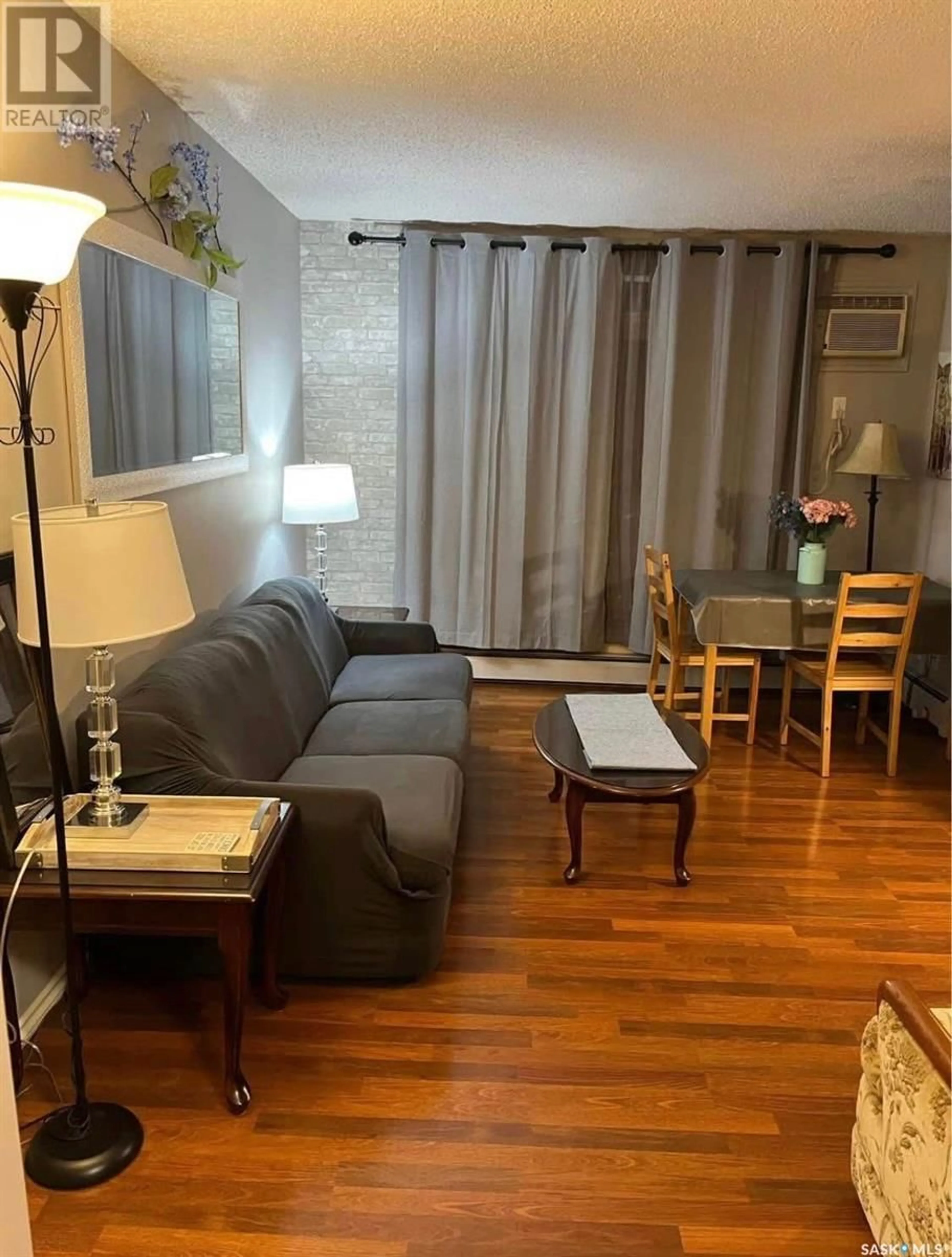 Living room with furniture, wood/laminate floor for 11 1001 LANSDOWNE AVENUE, Saskatoon Saskatchewan S7H2C2