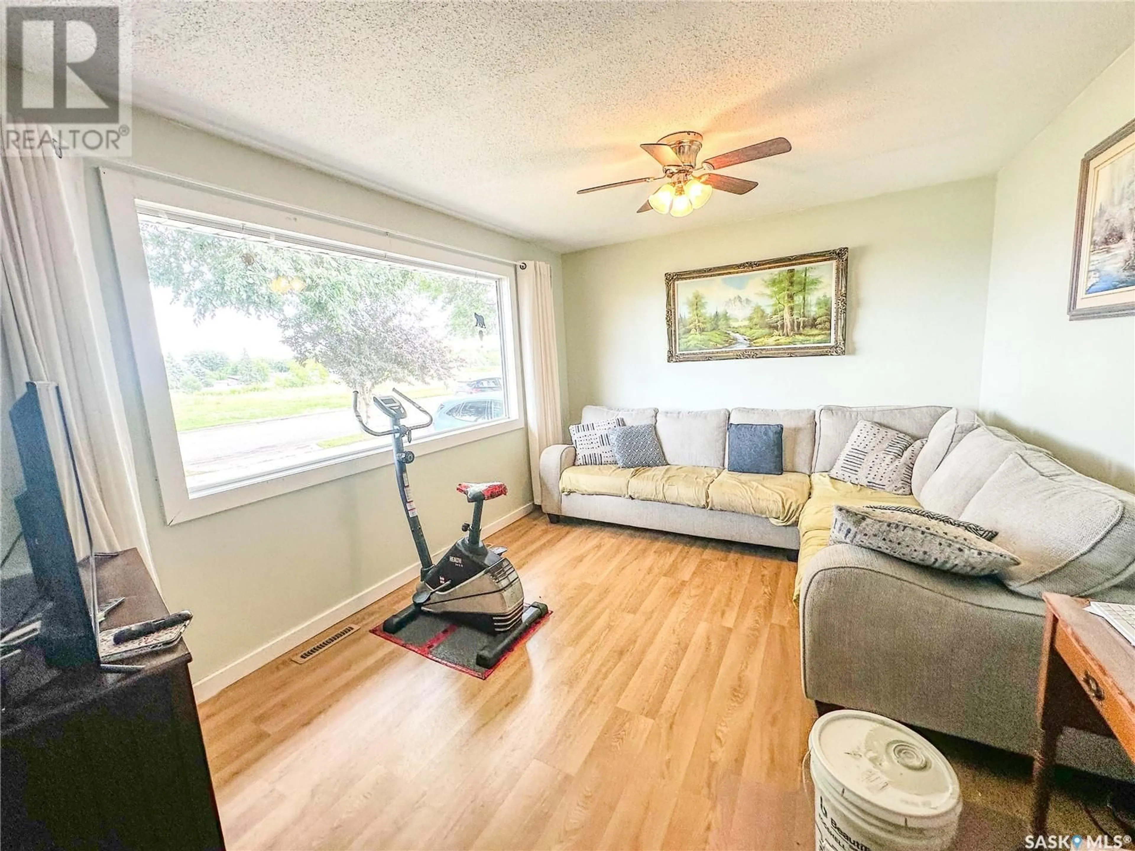 Living room with furniture, wood/laminate floor for 390 VICTORIA AVENUE, Yorkton Saskatchewan S3N3J8