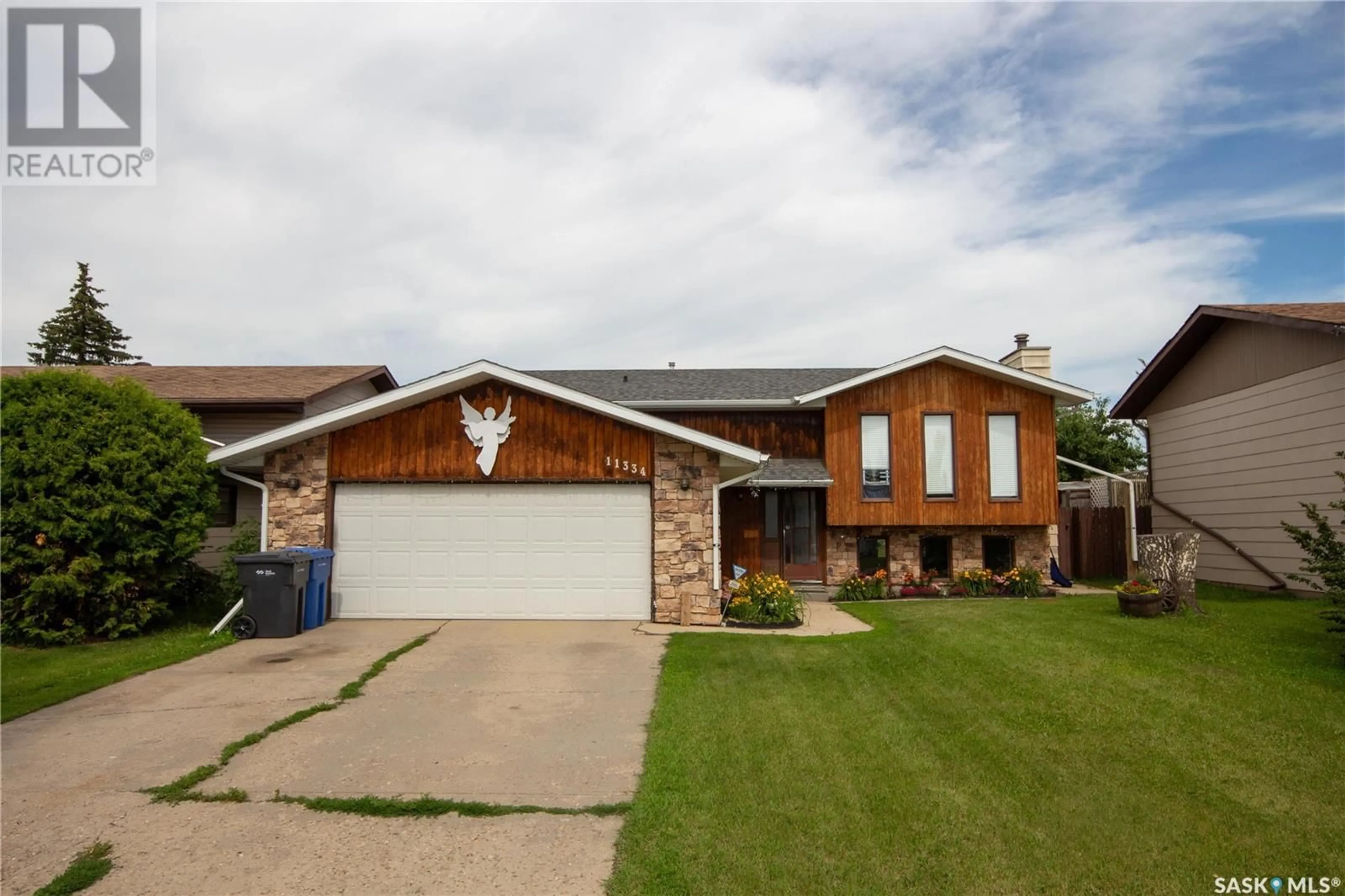 Home with brick exterior material, street for 11334 CLARK DRIVE, North Battleford Saskatchewan S9A3P3
