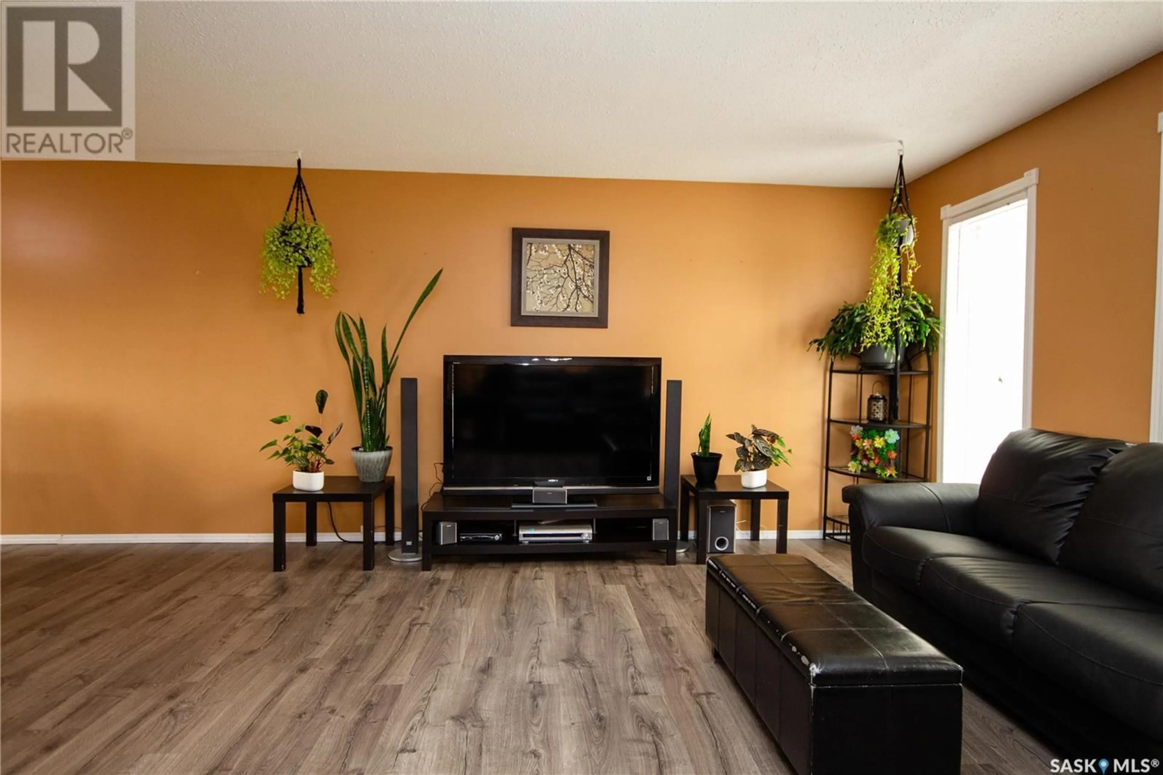 Living room with furniture, wood/laminate floor for 11334 CLARK DRIVE, North Battleford Saskatchewan S9A3P3