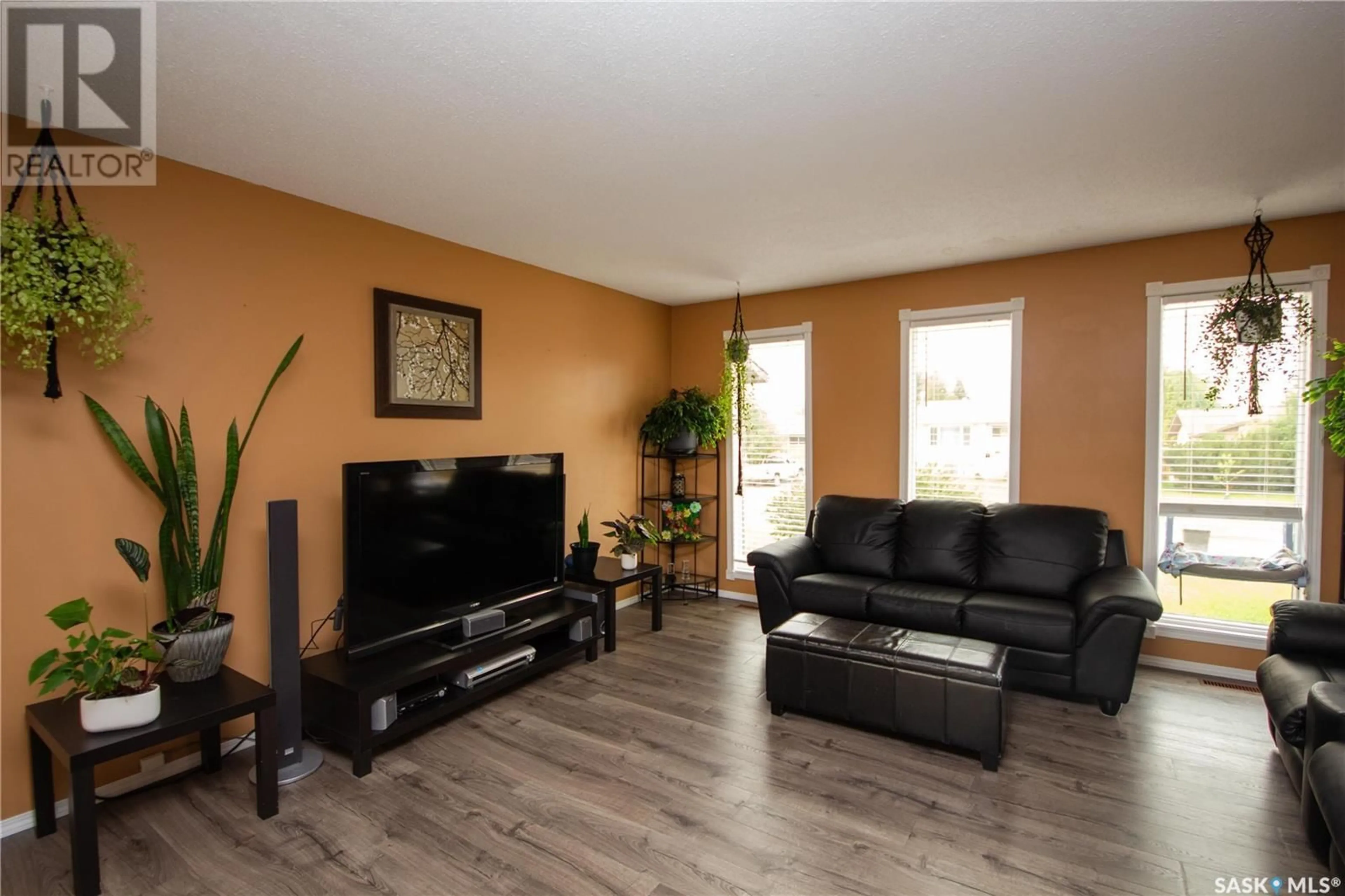 Living room with furniture, wood/laminate floor for 11334 CLARK DRIVE, North Battleford Saskatchewan S9A3P3