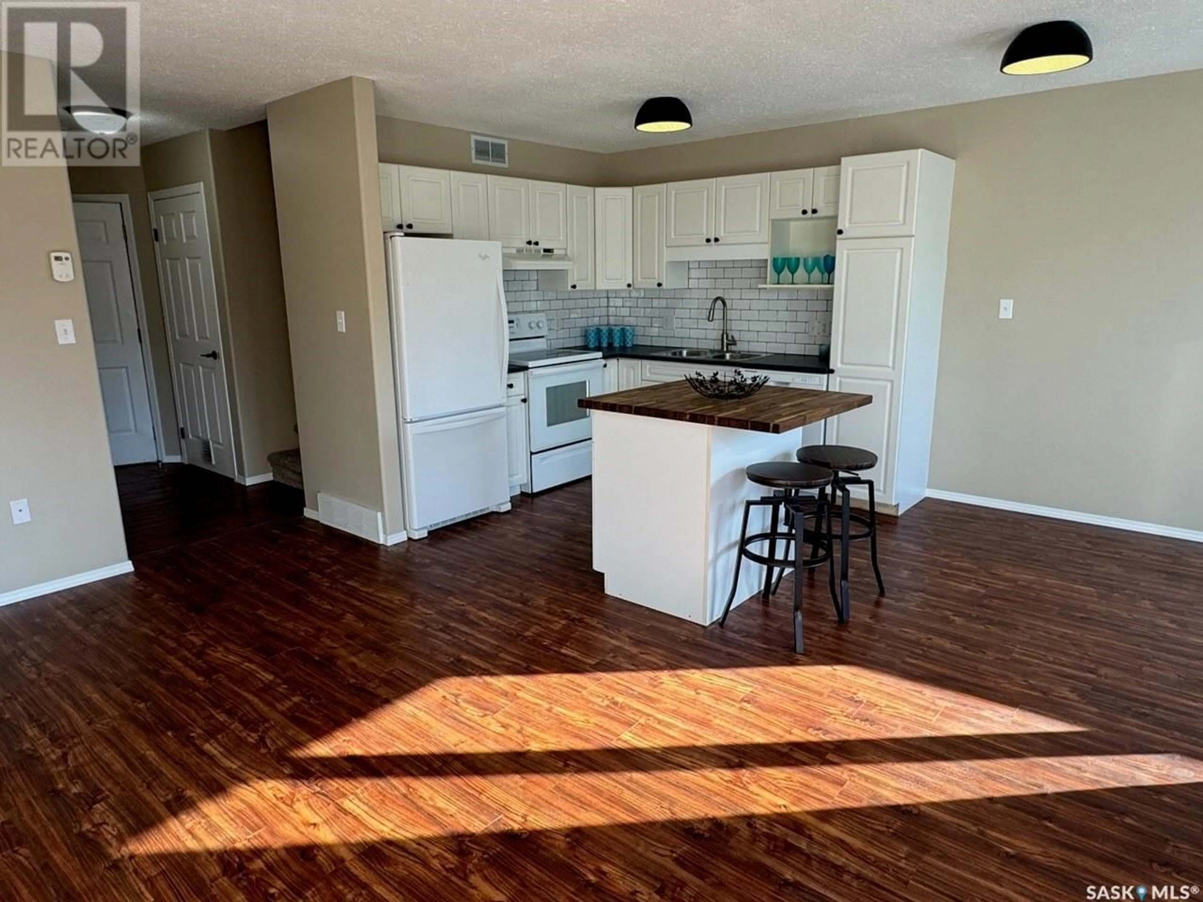 Open concept kitchen, wood/laminate floor for 12 1327 STUDER STREET, La Ronge Saskatchewan S0J1L0
