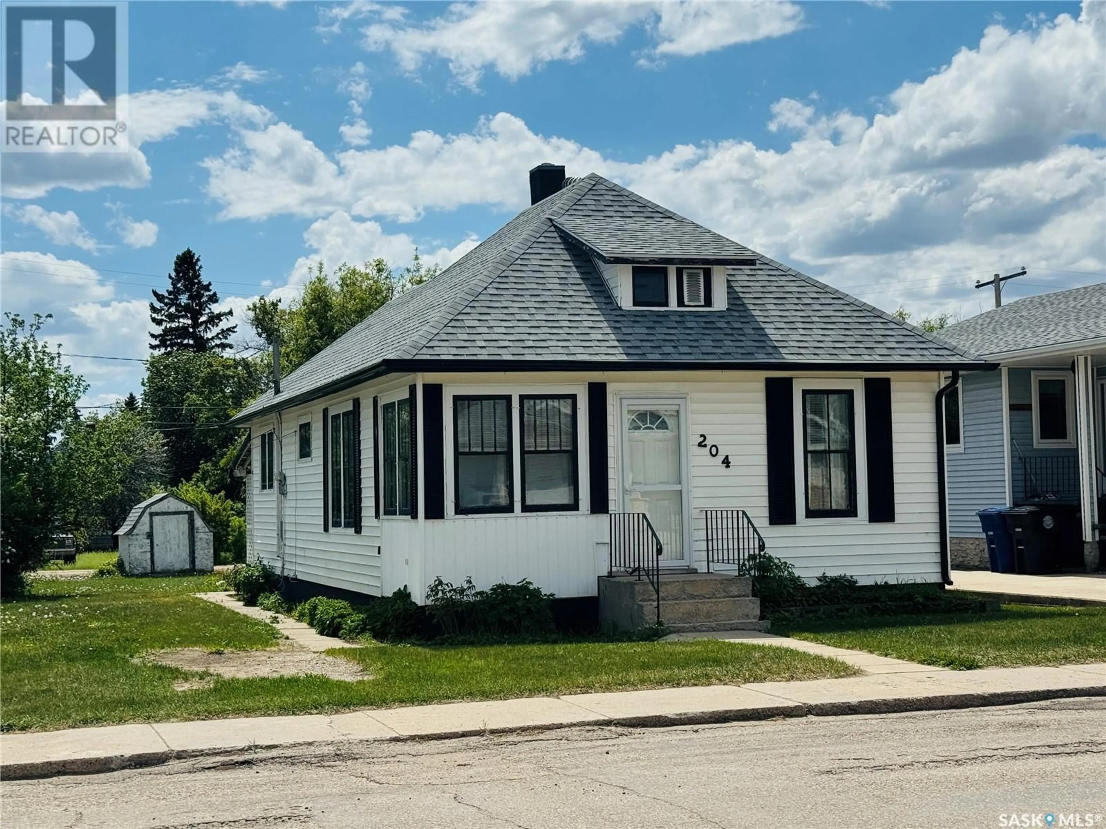 Home with vinyl exterior material, street for 204 5TH AVENUE, Biggar Saskatchewan S0K0M0