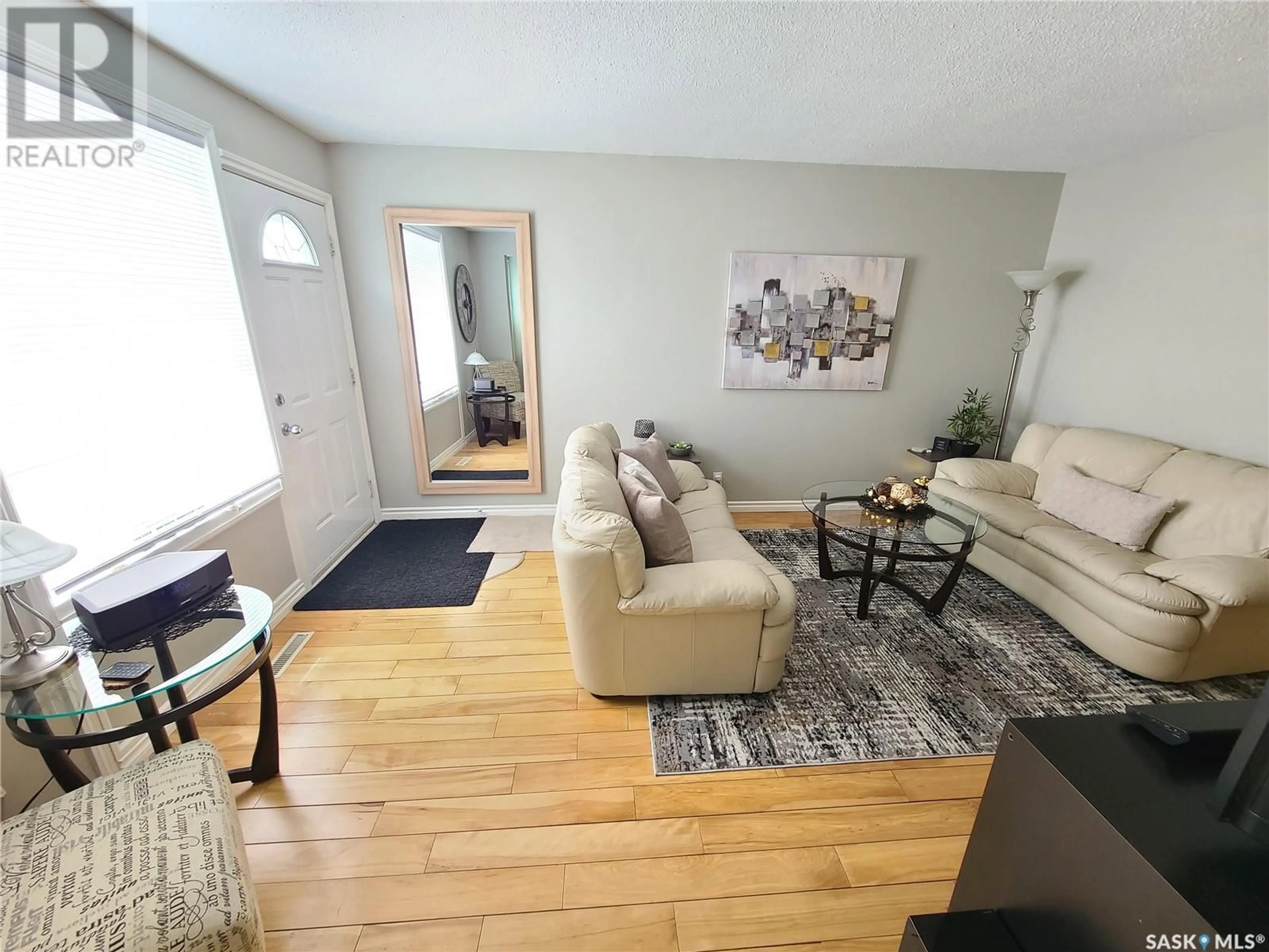 Living room with furniture, wood/laminate floor for 12 1292 GORDON ROAD, Moose Jaw Saskatchewan S6H3E5