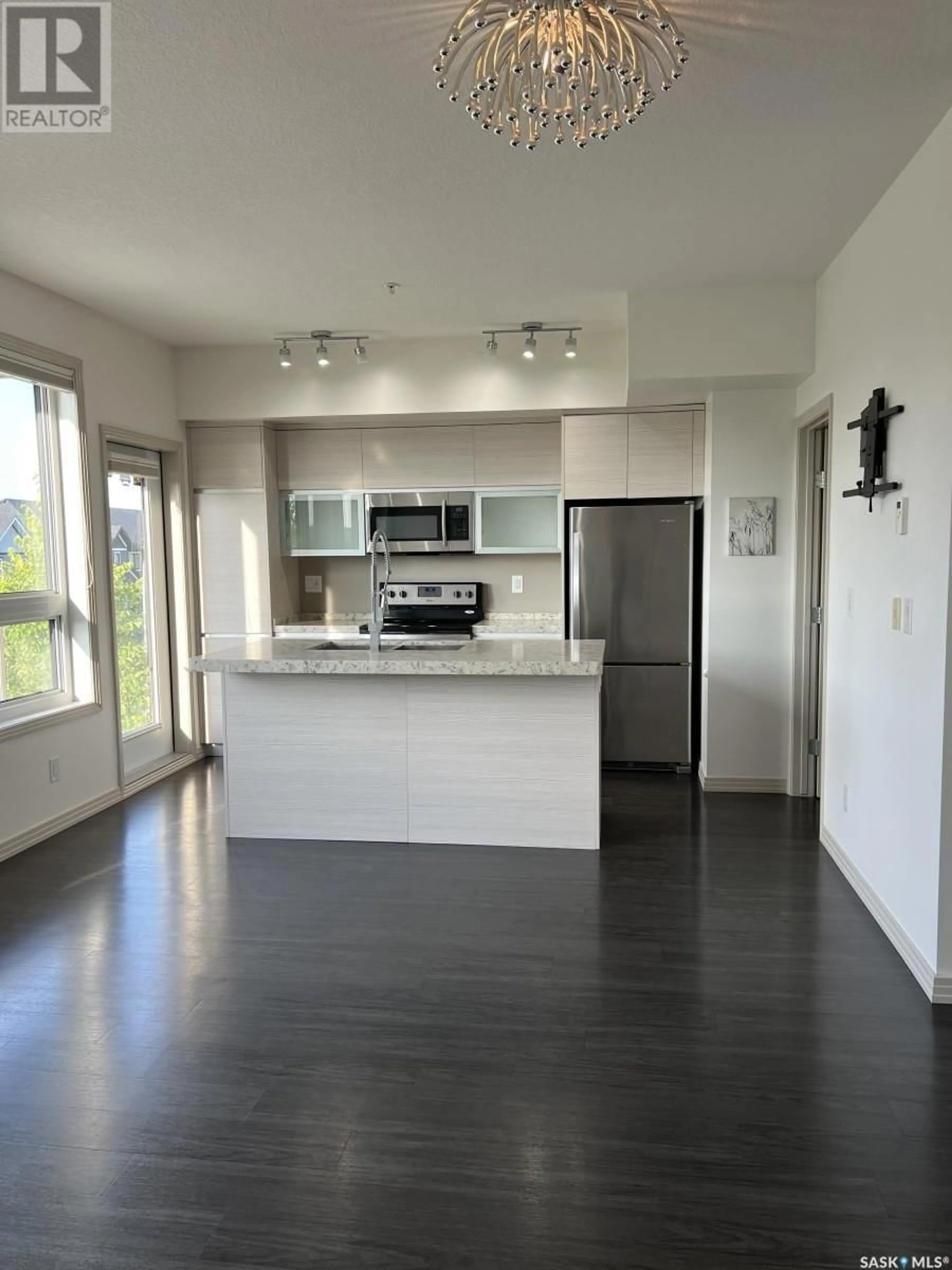 Open concept kitchen, wood/laminate floor for 218 223 EVERGREEN SQUARE, Saskatoon Saskatchewan S7M4T2