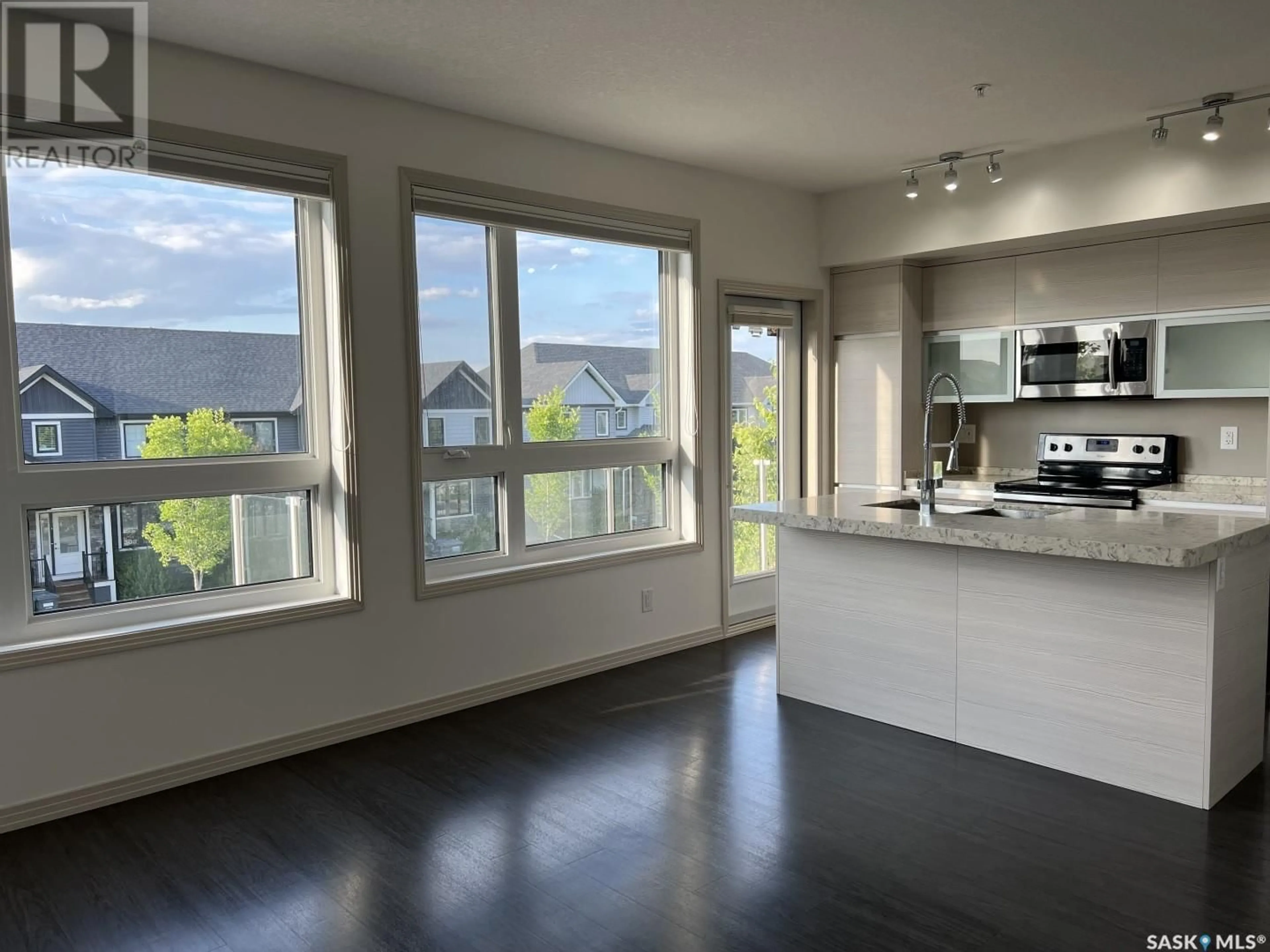 Open concept kitchen, wood/laminate floor for 218 223 EVERGREEN SQUARE, Saskatoon Saskatchewan S7M4T2