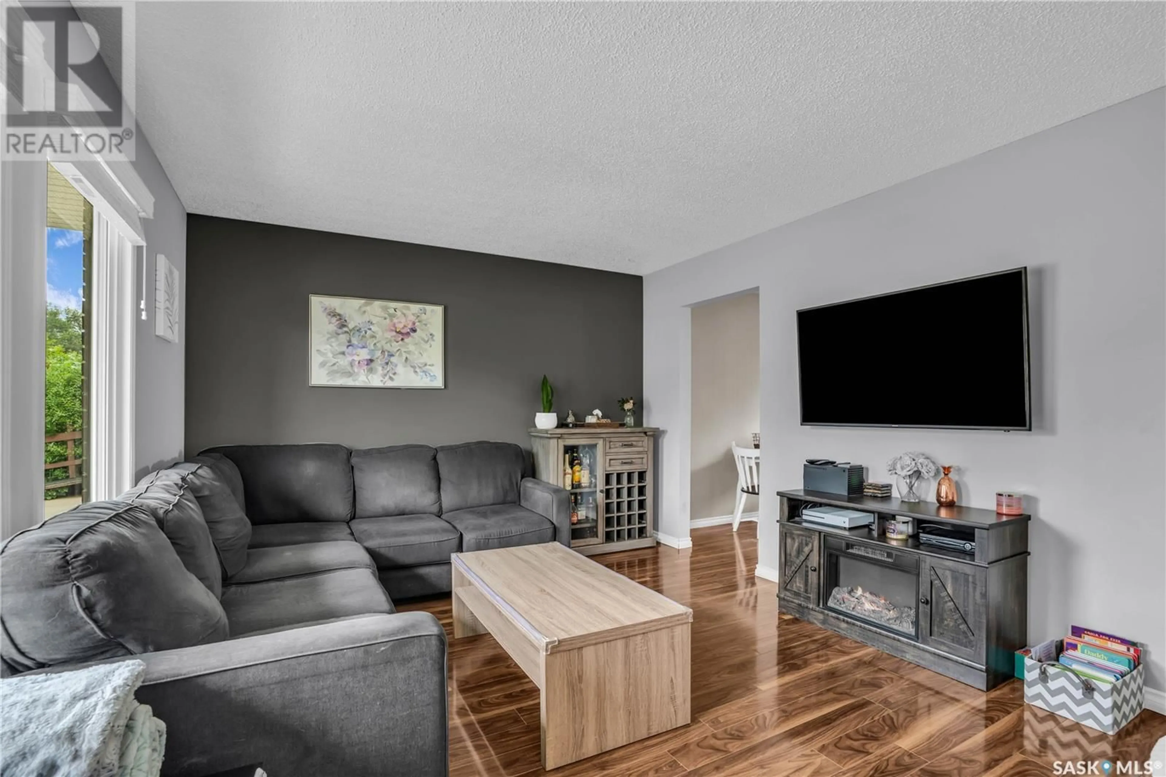 Living room with furniture, wood/laminate floor for 622 HIGHLANDS CRESCENT, Saskatoon Saskatchewan S7H4Y4