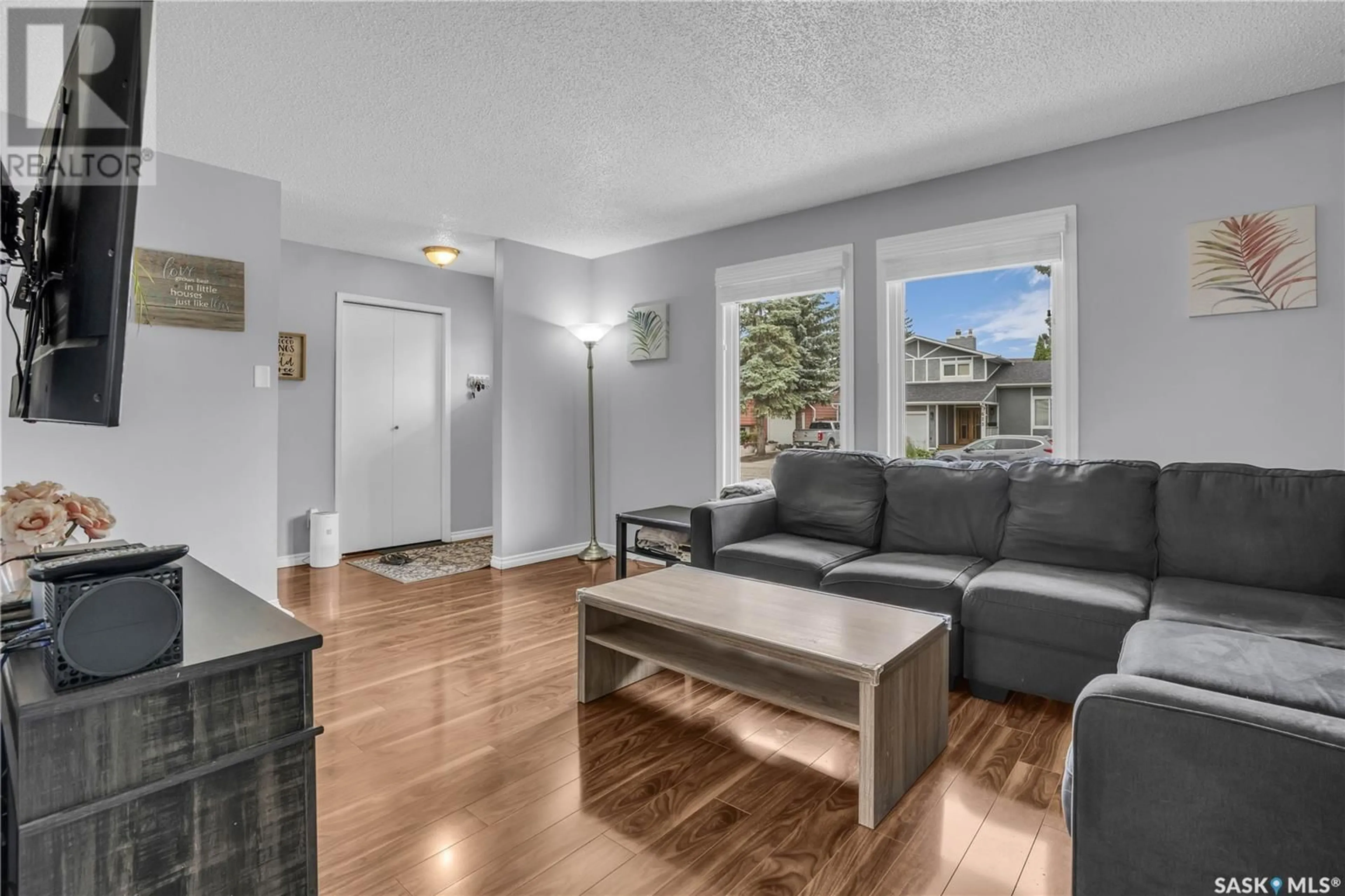 Living room with furniture, wood/laminate floor for 622 HIGHLANDS CRESCENT, Saskatoon Saskatchewan S7H4Y4