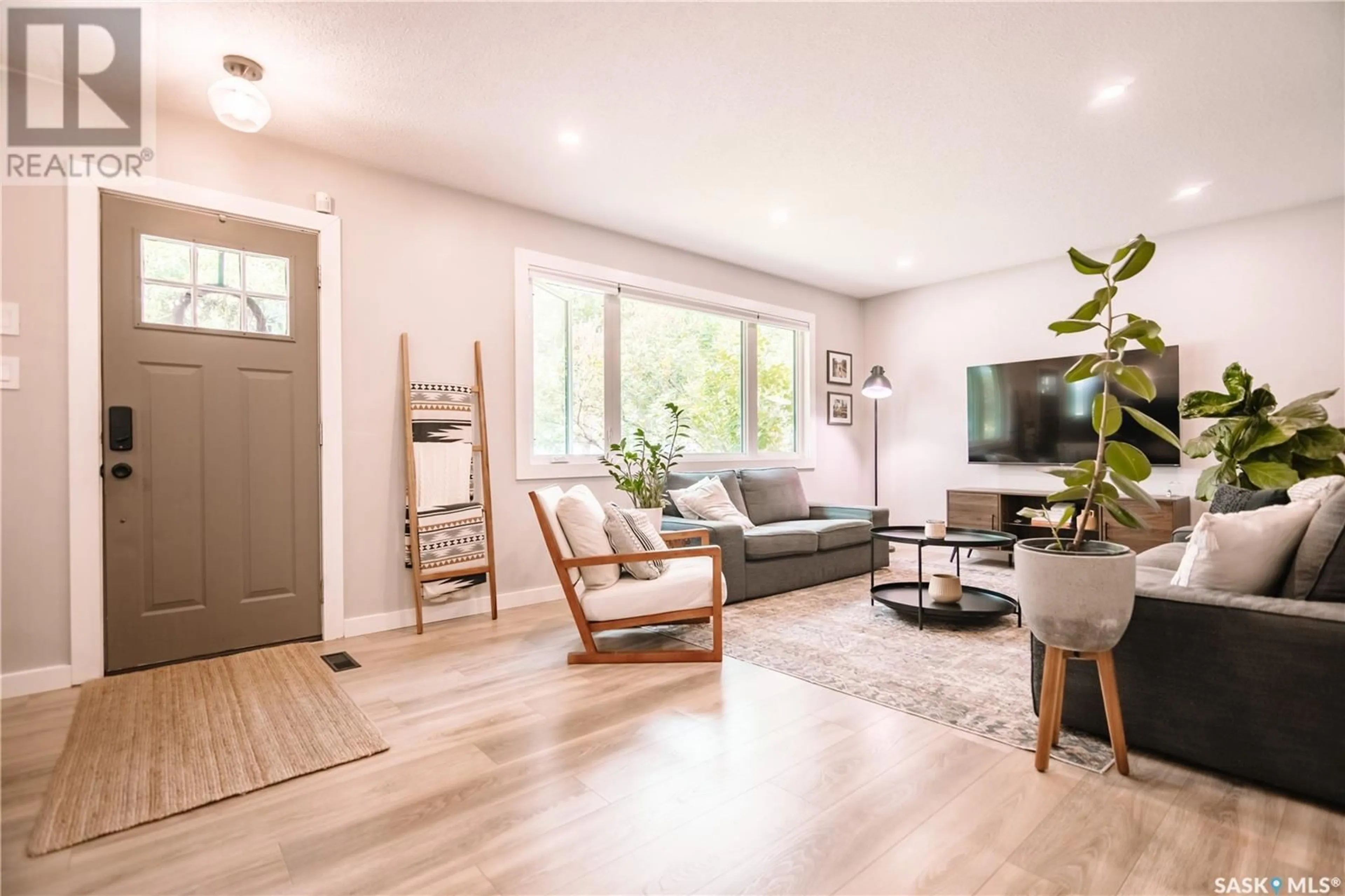 Living room with furniture, wood/laminate floor for 745 SWEENEY STREET, Regina Saskatchewan S4T6H7