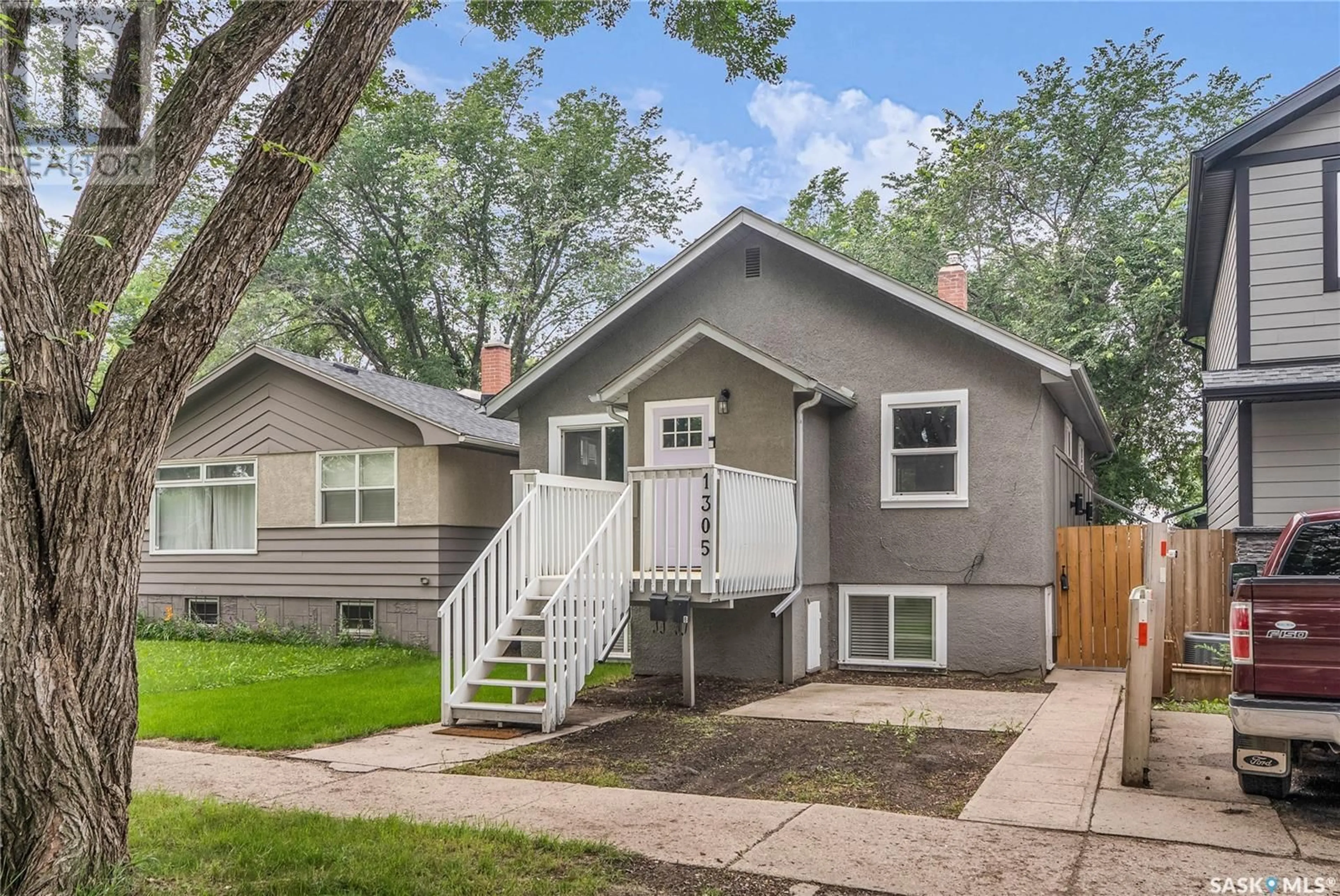 Home with vinyl exterior material, street for 1305 D AVENUE, Saskatoon Saskatchewan S7L1P2