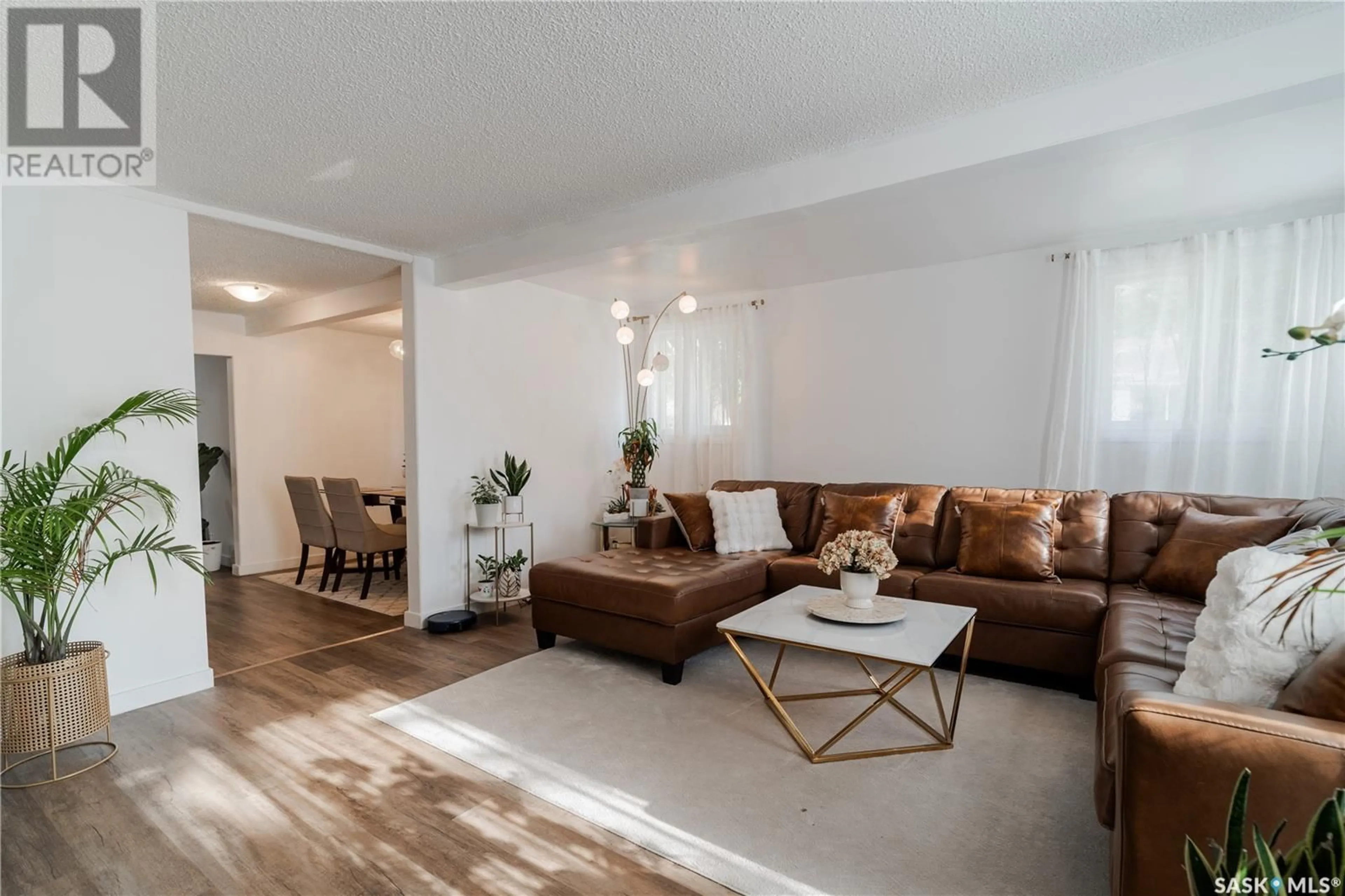 Living room with furniture, wood/laminate floor for 1619 LORNE AVENUE, Saskatoon Saskatchewan S7H1Y2