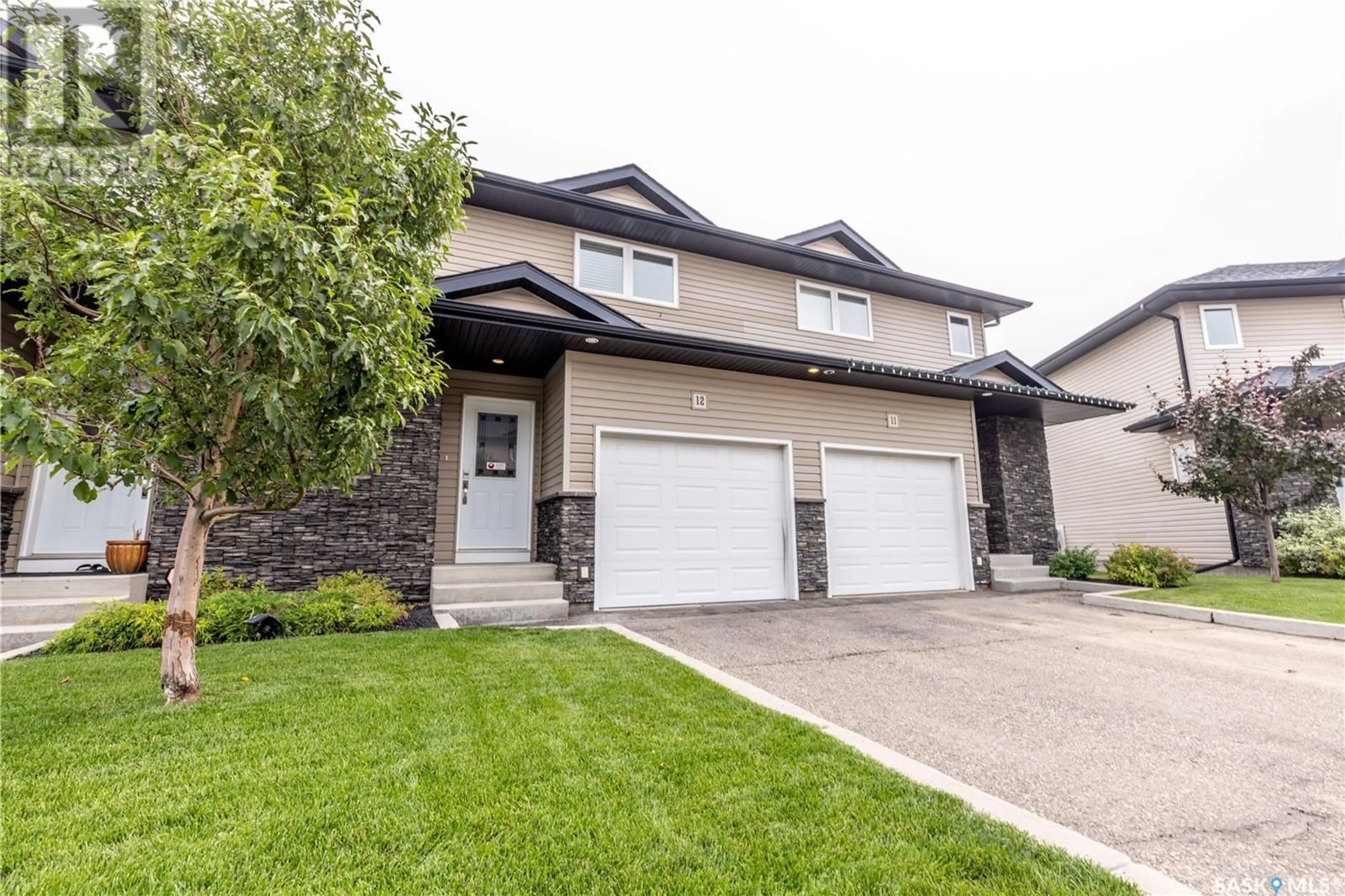 Home with vinyl exterior material, street for 12 365 DAWSON CRESCENT, Saskatoon Saskatchewan S7R0L6
