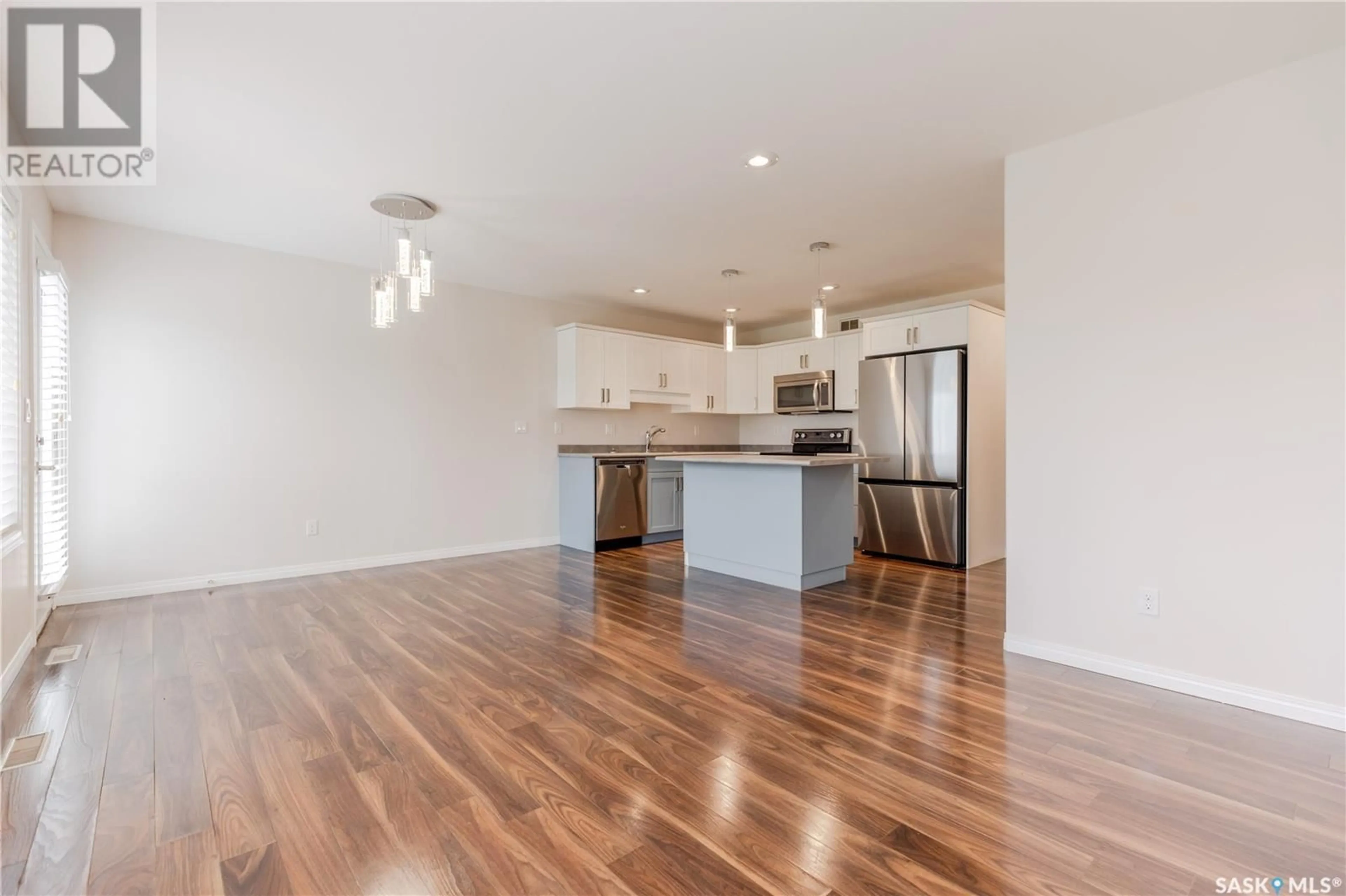 Open concept kitchen, wood/laminate floor for 12 365 DAWSON CRESCENT, Saskatoon Saskatchewan S7R0L6