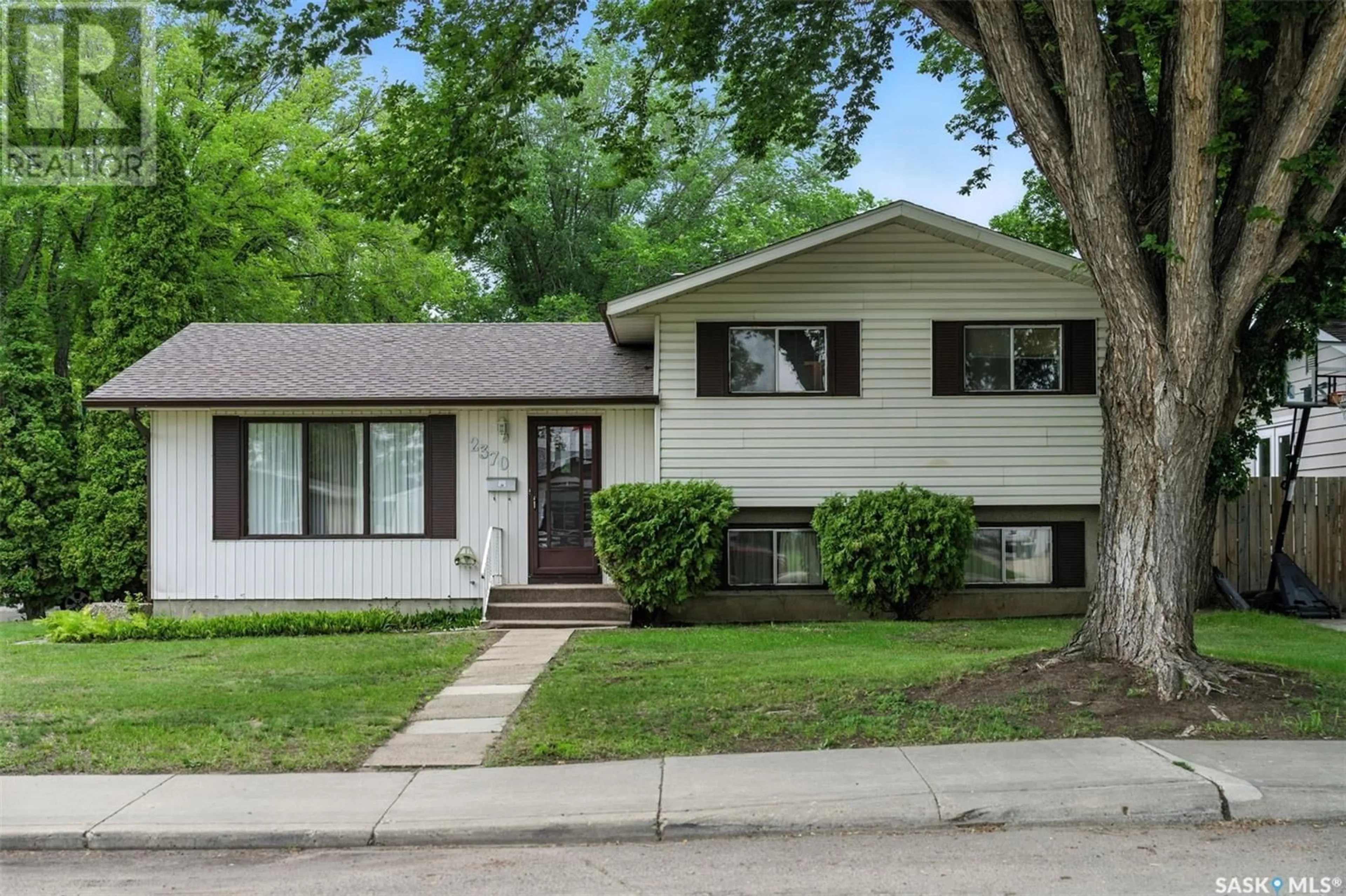 Home with vinyl exterior material, street for 2370 EASTHILL, Saskatoon Saskatchewan S7J3E5