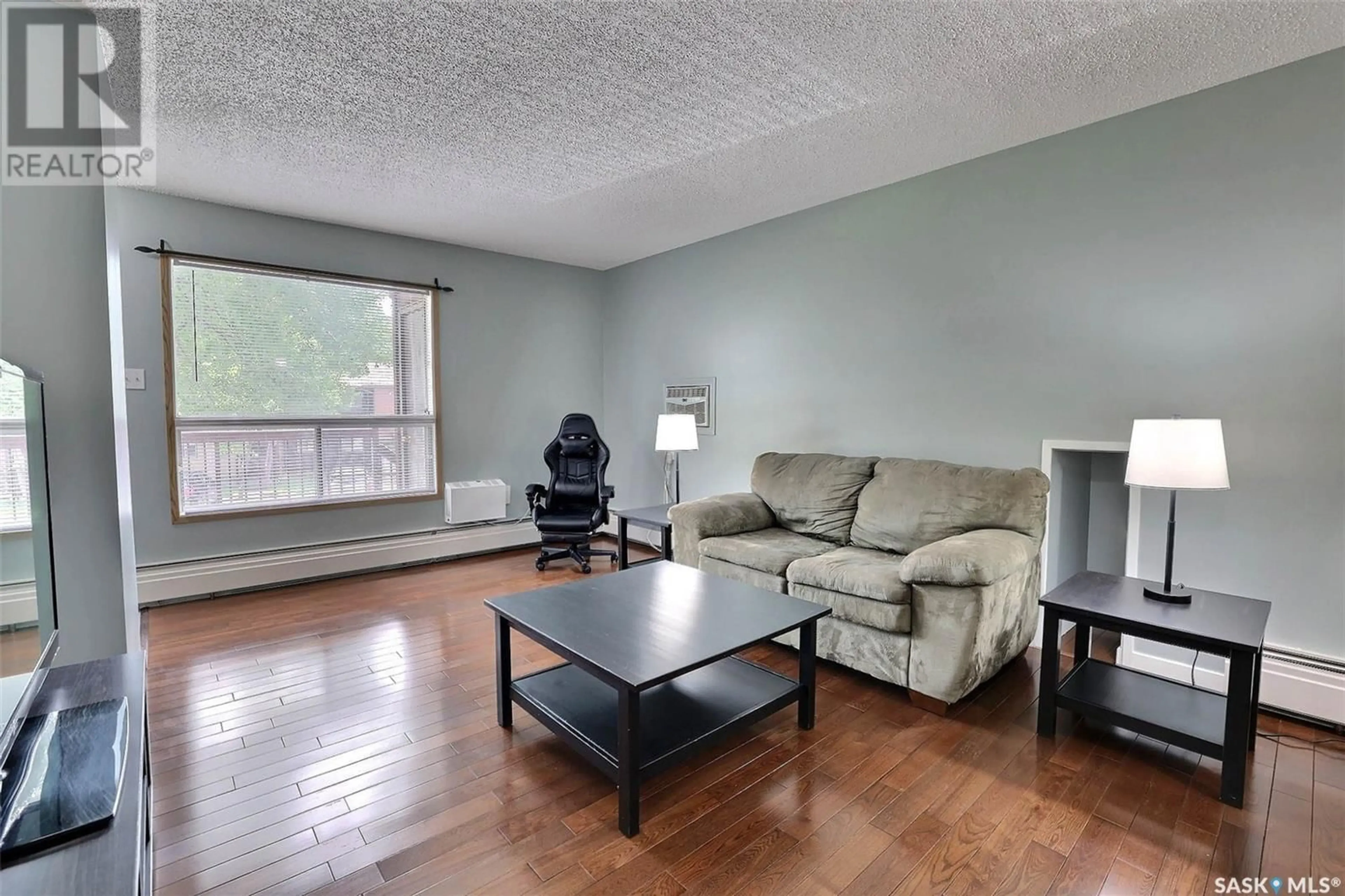 Living room with furniture, wood/laminate floor for 208A - 1350 GORDON ROAD, Moose Jaw Saskatchewan S6H7R9
