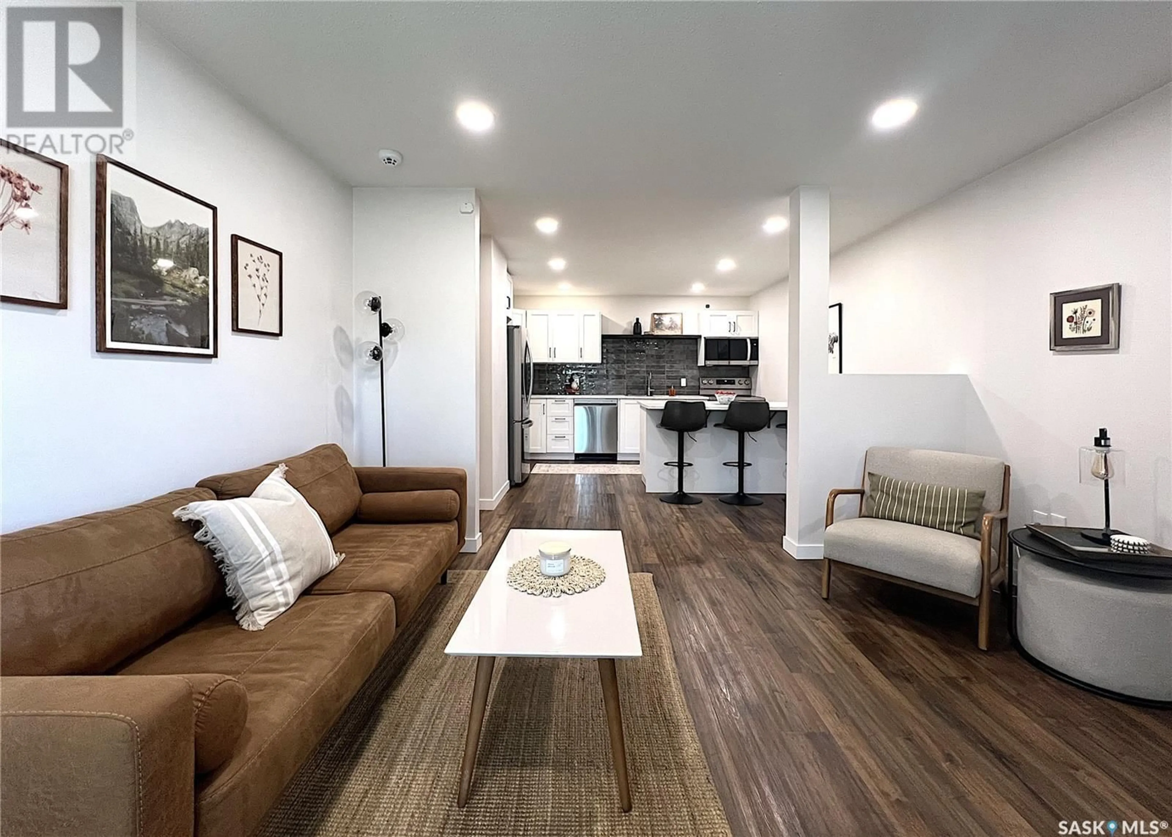 Living room with furniture, wood/laminate floor for 306 - 307 PERKINS STREET, Estevan Saskatchewan S4A2K1