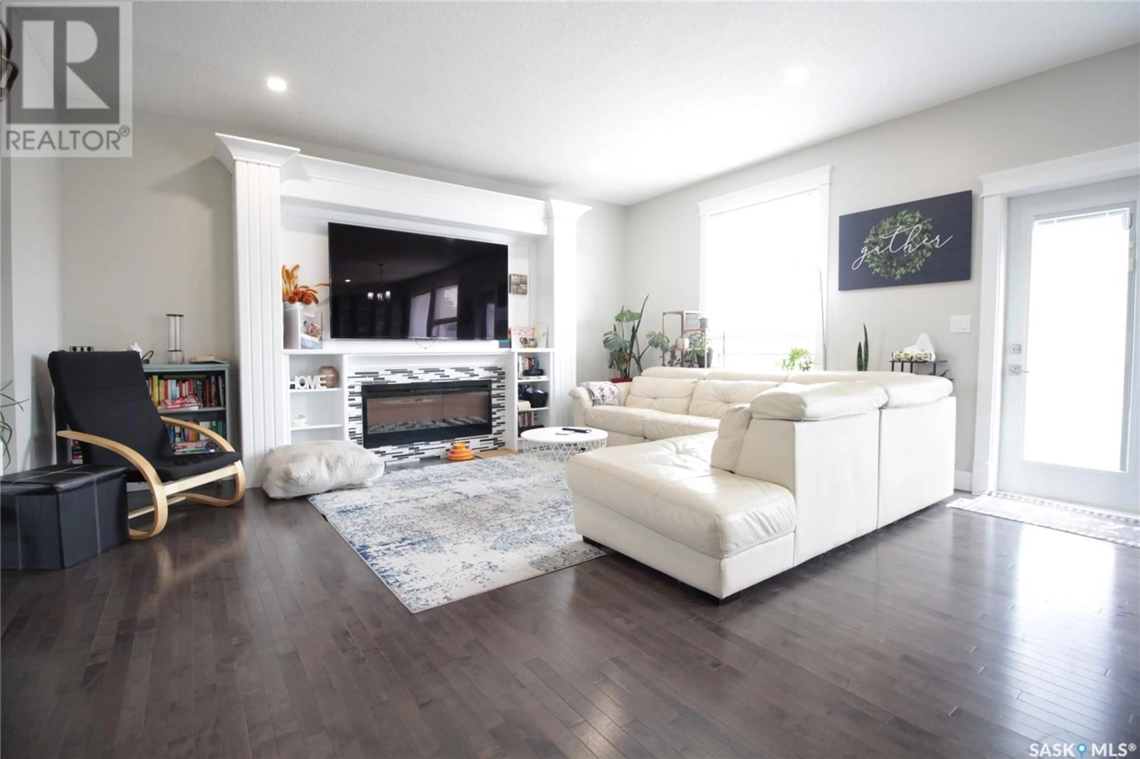 Living room with furniture, wood/laminate floor for 313 COOK ROAD, Moosomin Saskatchewan S0G3N0