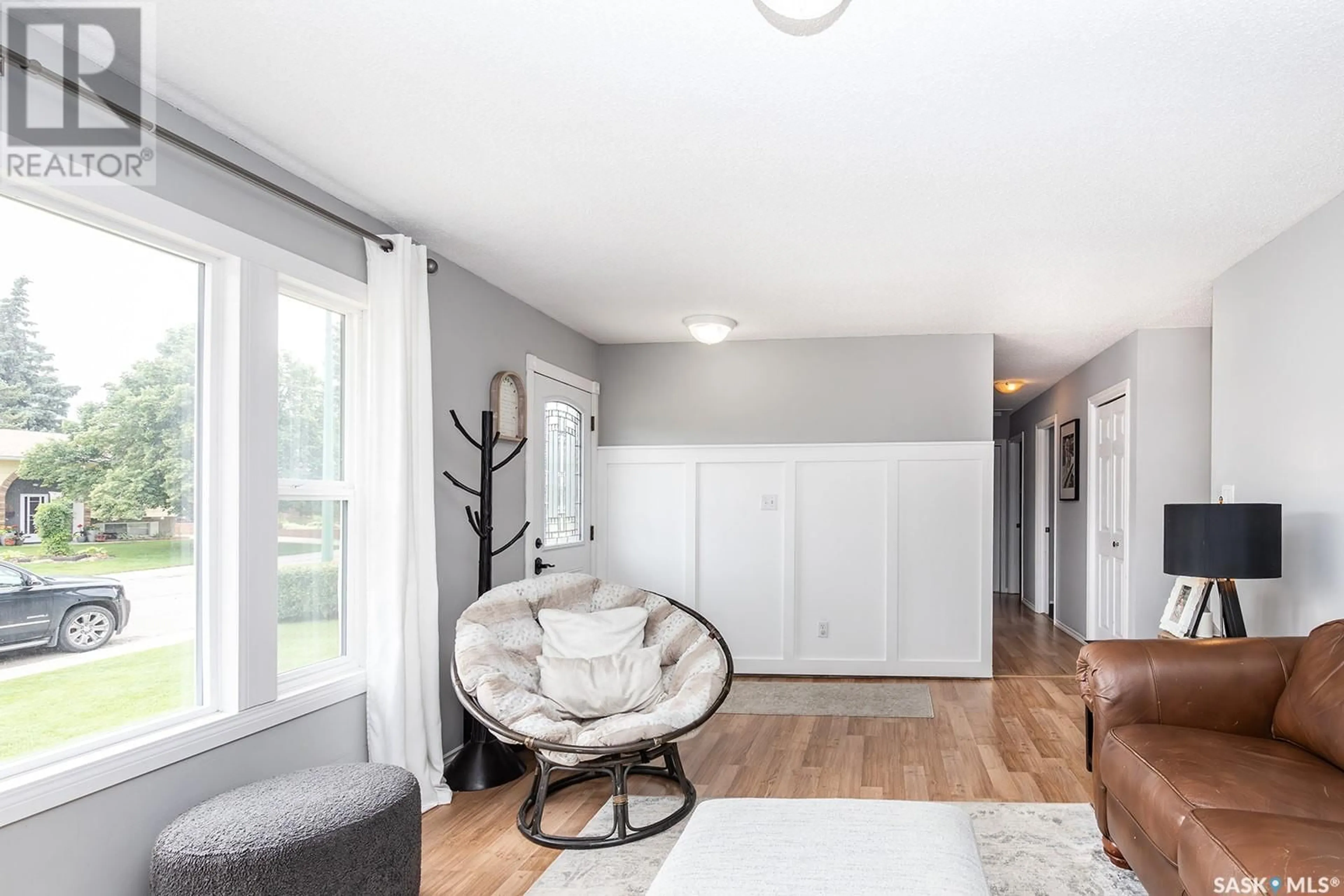 Living room with furniture, wood/laminate floor for 34 BEURLING CRESCENT, Saskatoon Saskatchewan S7H0T6
