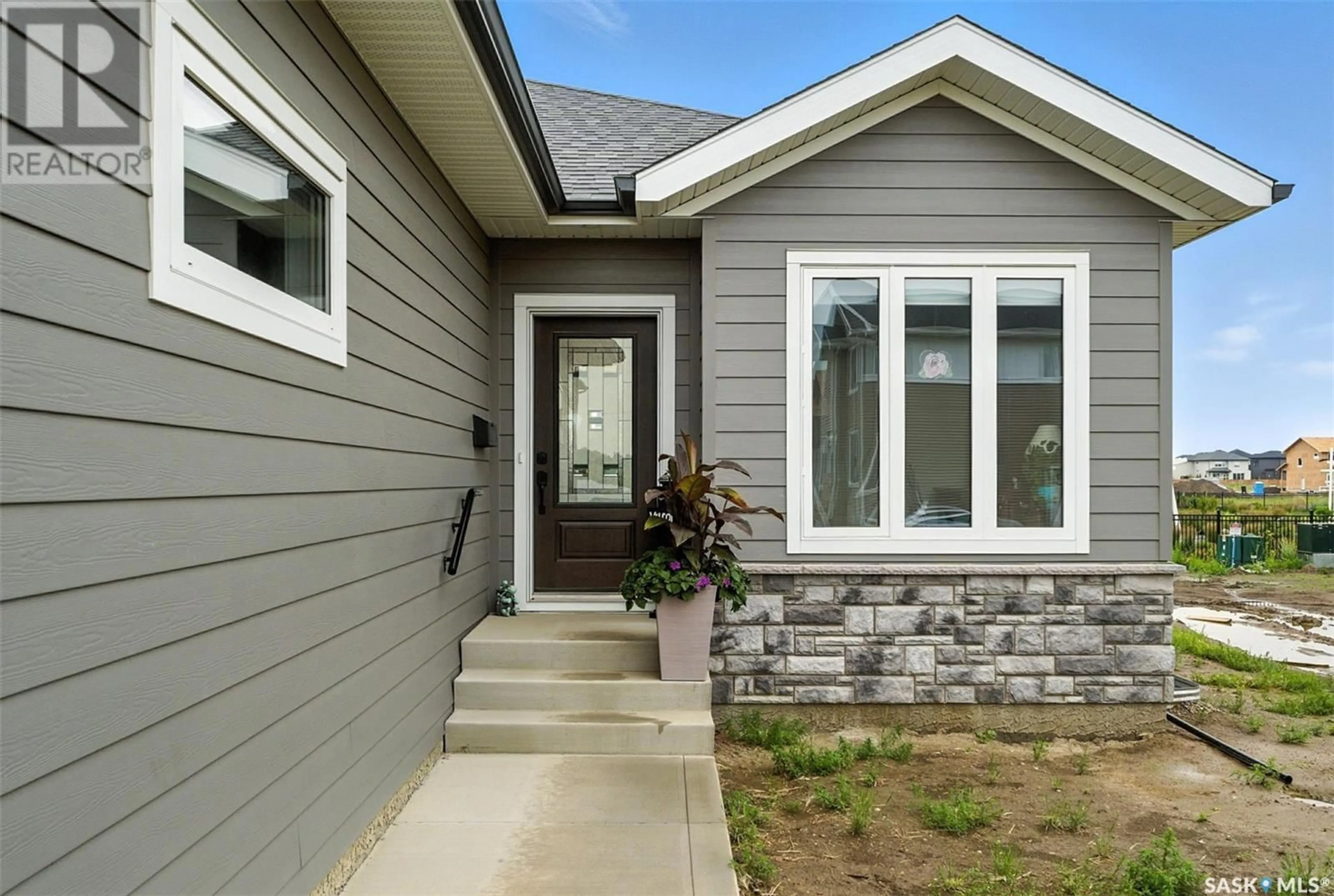 Home with vinyl exterior material, street for 147 KATZ AVENUE, Saskatoon Saskatchewan S7V1S8