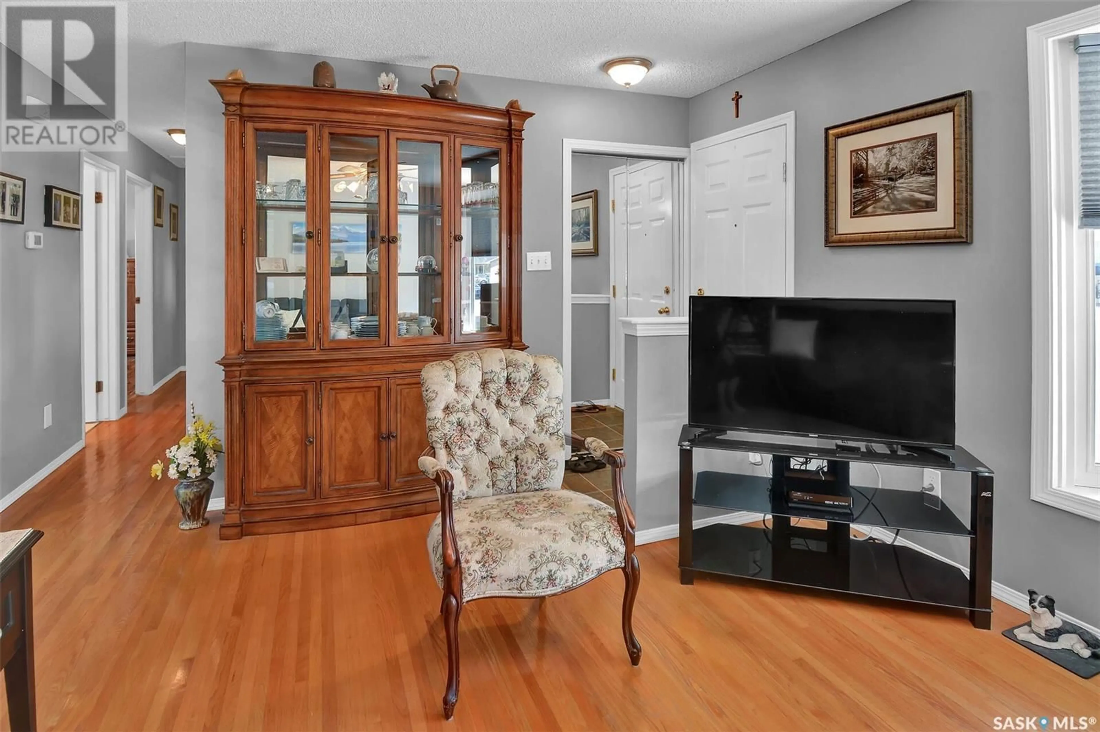 Living room with furniture, wood/laminate floor for 2106 37TH STREET, Saskatoon Saskatchewan S7L4S3